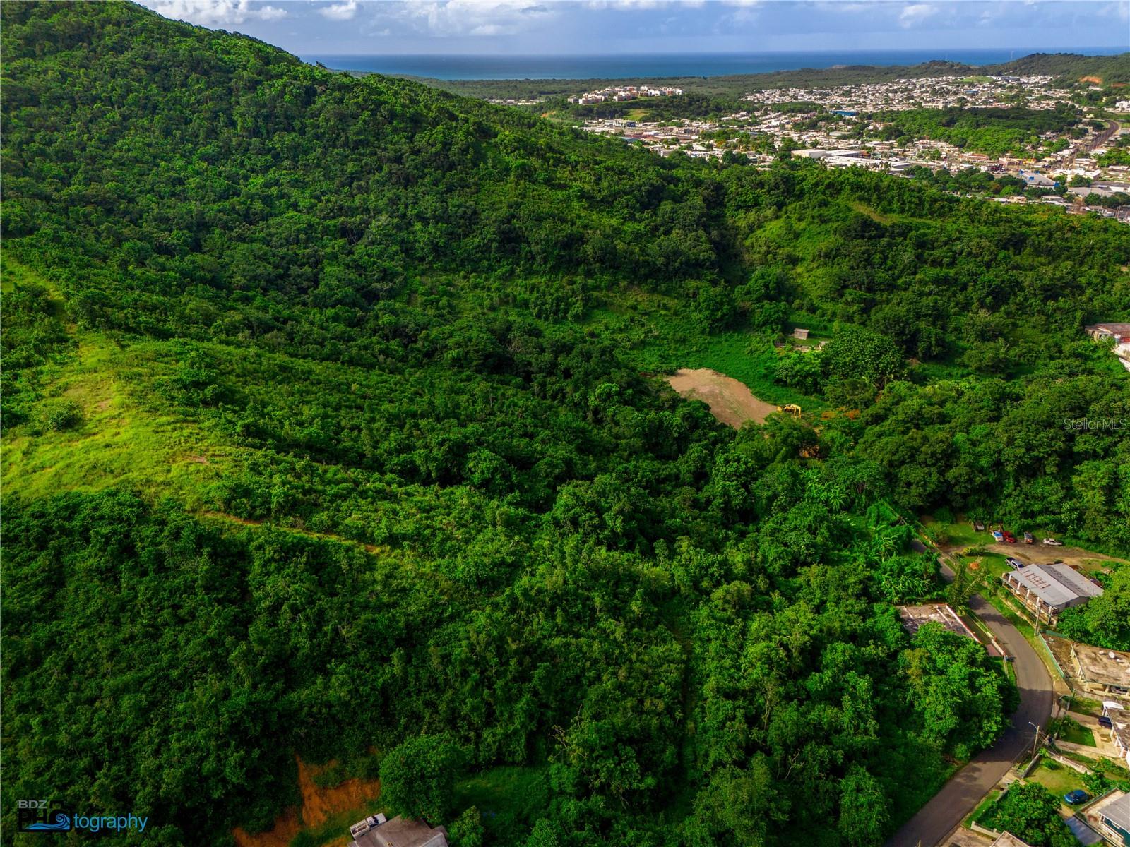 One or more photo(s) has been virtually staged. Exceptional investment and development opportunity in Quebrada, Fajardo: 20 cuerdas (~19.4 acres) of raw land zoned Residential-Intermediate (R-I) with roadway access and a strategic East Coast location minutes from beaches, marinas, and major attractions; offered as raw land ideal for land banking, a large-scale residential community, hospitality, or other R-I–compatible uses, and—for an additional cost—with the potential delivery of approved endorsements (endosos) that could support a program of up to ~430 residential units, subject to final agency approvals; this optional entitlement pathway enables a buyer to hold a prime asset with appreciation upside or move immediately toward a master plan that accelerates timelines and reduces entitlement risk in a dynamic submarket driven by tourism and regional employment, with sustained housing demand (workforce and mixed-income), strong connectivity to primary corridors, and fundamentals that support absorption and long-term value; key attributes include the contiguous 20-cuerda scale, favorable R-I zoning, phaseable development potential, and flexible exit strategies; buyer to independently verify zoning, density, utilities, environmental matters, and all permits/approvals; information deemed reliable but not guaranteed; seller may assist, at buyer’s expense, with the transfer and administration of endorsements.