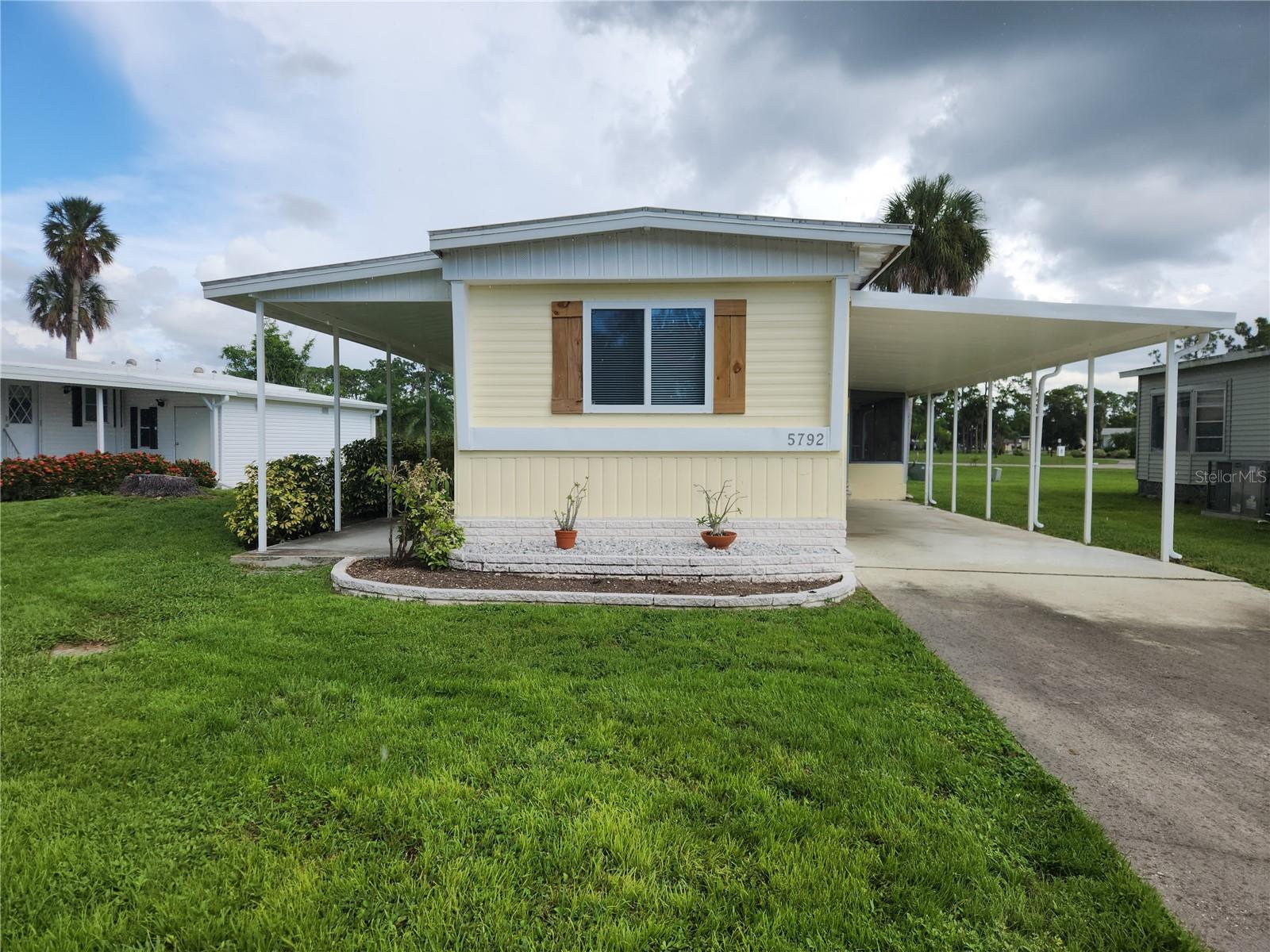 Your North Port oasis awaits you and your fur-babies! This charming 2-bedroom, 2-bath, newly painted coach is located in Holiday Park and offers comfortable living with fantastic updates. Step inside and discover a kitchen featuring blue painted wood cabinets, pristine white appliances, including a sleek glasstop stove, and a convenient pantry. You'll even find an additional storage cabinet with a stylish butcher block countertop, perfect for extra prep space. Enjoy the Florida sunshine with not one, but two outdoor living spaces – a screened lanai for bug-free relaxation and a covered patio, ideal for al fresco dining. This home boasts significant peace-of-mind upgrades, including a new roof in 2023, a new AC in 2019, and a new hot water heater in 2020. The electrical system was also updated with a newer 220 service electric box in 2016. There is a large living room and a family room with sliders to the covered patio. This coach is located close to the newly renovated clubhouse with swimming pool. Don't miss out on this move-in-ready gem in a desirable community! Holiday Park is a premier land-owned, DEEDED community offering an exceptional lifestyle with a low monthly maintenance fee of $195 ($2,340.00/year), conveniently included in your tax bill. Residents enjoy access to two well-appointed clubhouses, two inviting swimming pools, and a comprehensive fitness center, ensuring ample opportunities for relaxation and recreation. The community is designed for active adult living, featuring tennis, pickleball, and bocce ball courts, along with a variety of indoor and outdoor games such as billiards, shuffleboard, and horseshoes. With ping pong tables, a card room, and dart boards, residents can engage in numerous social activities, all set within a beautifully landscaped park-like environment. This is the place for you and your furr-babies!