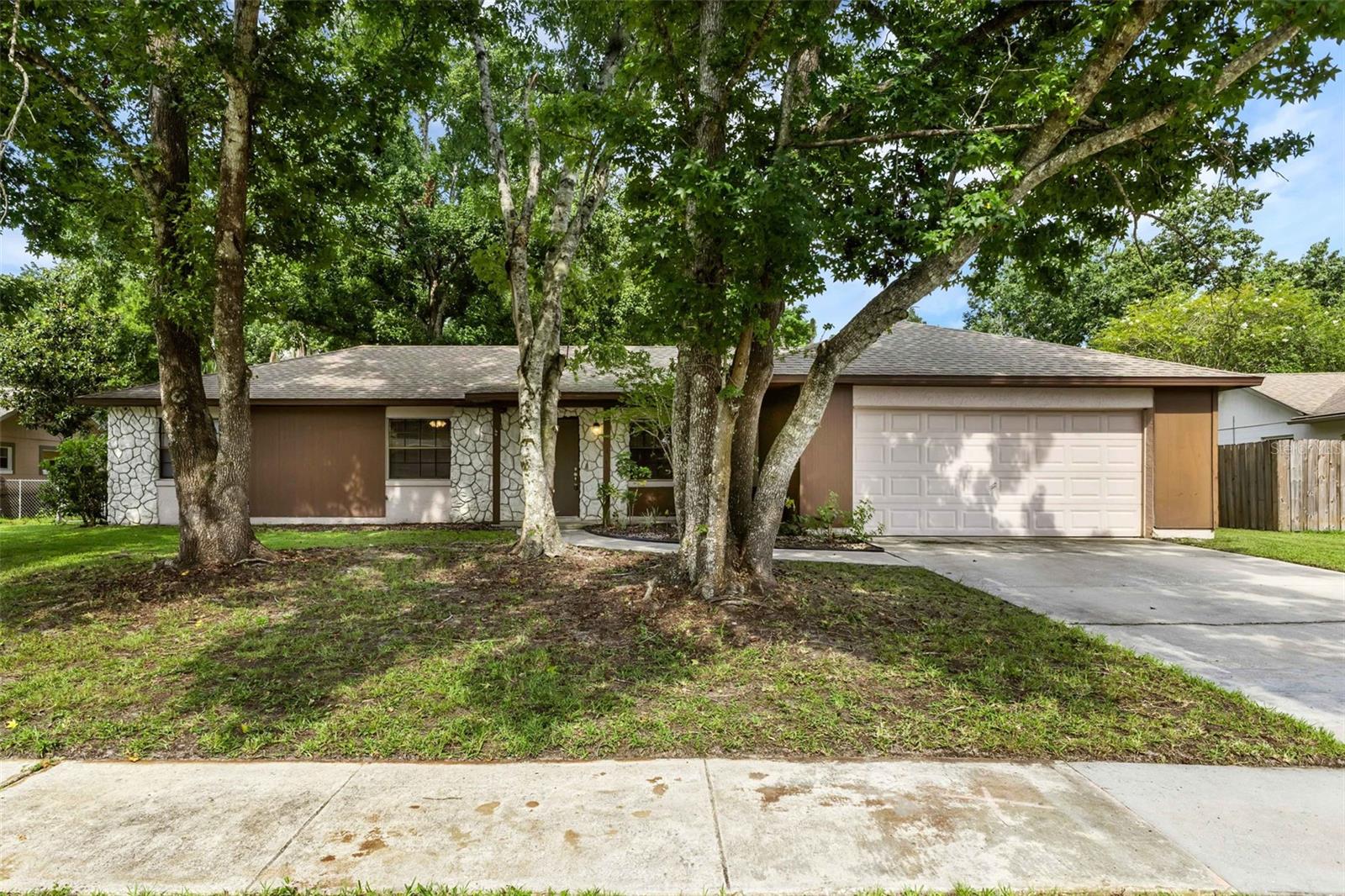 Welcome home to this 4 bedroom 2 bath in the heart of Winter Springs! Walk thru the front door to be wowed with LVP flooring and a spacious living space with large windows letting in natural light. The eat-in space in the kitchen features French doors leading out into the oversized backyard perfect for a summer game of baseball or even a firepit for those cool FL nights. Kitchen has updated real wood cabinets with plenty of space for all those kitchen essentials and granite countertops with new stainless appliances. Along with the master suite features LVP flooring, a new vanity with granite and a tub/shower combo. Other three bedrooms include LVP flooring and ample closet space. Guest bath also has a new vanity with granite too! Close to the bus line and convenient to major highways, shopping and dining. This home is well maintained and move-in ready for a buyer like YOU! Schedule a showing today as this home wont last long!