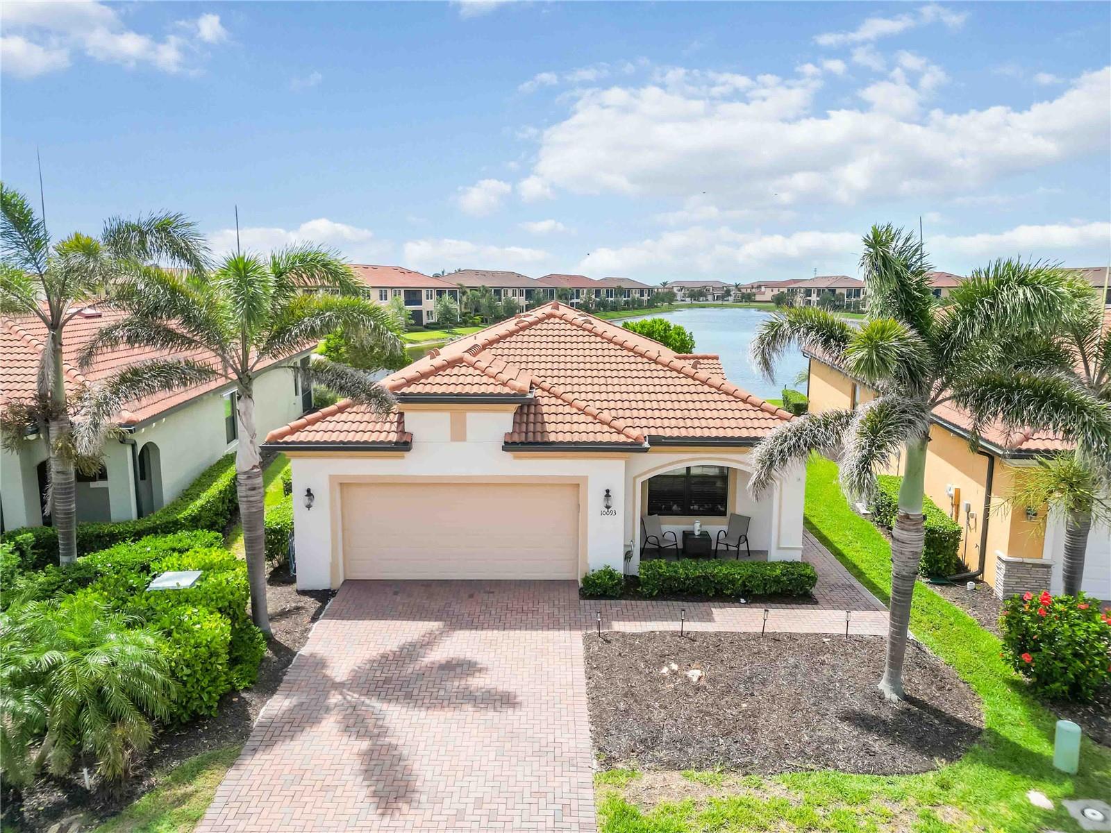Nestled in the highly sought-after Lake Village of Sarasota National, this stunning Roma floor plan offers the perfect combination of elegance and functionality. Boasting 2 bedrooms, a versatile flex room, and 2 bathrooms, this home provides 1,907 sq. ft. of refined living space with water views from the enclosed lanai - an ideal spot to relax in privacy.
As you enter, a designated foyer leads to a spacious den/flex room with tile floors and double glass doors, providing a flexible space that could easily serve as a third bedroom or home office. The heart of the home is the chef-inspired kitchen, featuring stainless steel appliances, custom backsplash, sparkling granite countertops, and ample cabinet storage. A large island enhances the kitchen's functionality, serving as both a workspace and gathering spot for friends and family.
Adjacent to the kitchen, the dining area is flooded with natural light from oversized windows, and enhanced by a custom framed mirror, creating a bright, inviting space perfect for entertaining. The living room has a built-in electric fireplace and decorative wall which add to this homes charm.
The primary suite serves as a peaceful retreat, with a spa-inspired en suite bathroom featuring a double sink vanity, seamless glass walk-in shower, linen closet, and a separate water closet for added privacy. A large walk-in closet provides generous storage space. The second bedroom, filled with natural light, is conveniently located next to a full bathroom, ensuring comfort and privacy for guests.
The convenience of a dedicated laundry room, complete with a new washer and dryer, built-in sink, and lower cabinet, adds practicality to daily living. The 2-car garage, featuring durable epoxy flooring and provides ample storage space.
Sarasota National offers a wealth of amenities, including a 30,000 sq. ft. clubhouse with resort-style pool, outdoor tiki bar, fine dining restaurant, fitness center, card room, bocce courts, pickleball, tennis, dog park, playground, and much more!. All set within this Audubon International Certified Signature Sanctuary, offering stunning water and preserve views.
Located just minutes from the Atlanta Braves spring training camp and the vibrant new Downtown Wellen Park, this home offers the ultimate in Florida living. Luxury, convenience, and a laid-back lifestyle await you at Sarasota National!