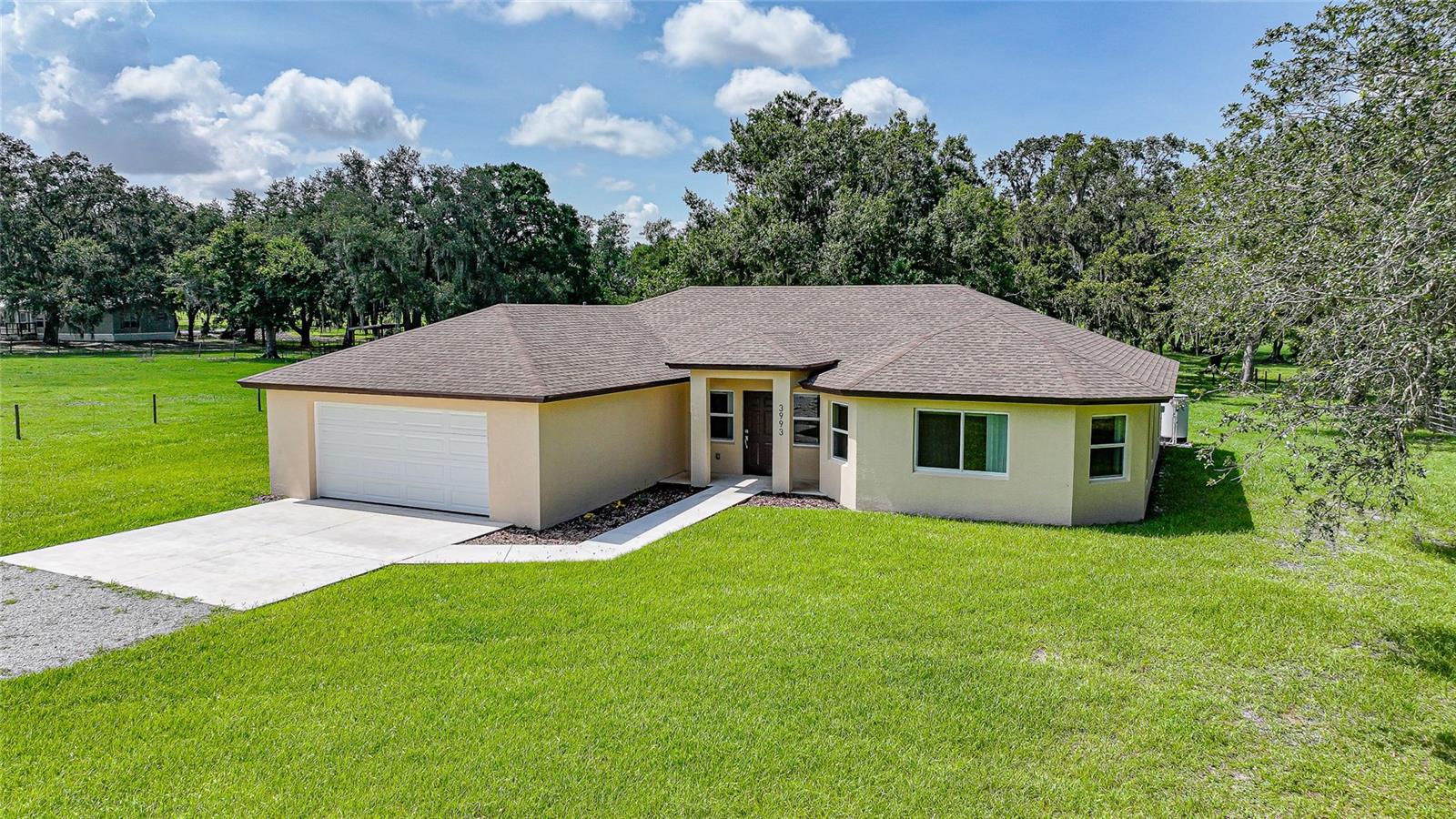 Built in 2024 and sitting pretty on 10 shady, dreamy acres, this home is fresh out of the box and ready for you to make it yours. Step inside and you’ll feel it immediately... that wide open layout that makes everything feel bigger, brighter, and just easier to live in. The kitchen is a total centerpiece with granite countertops, a huge island (hello, snack station), and open views to the spacious living and dining areas. Every room feels oversized, not just “technically fits a bed” big. We’re talking real space to stretch out, decorate, and live. There’s a split-bedroom layout for privacy, a bonus room for whatever your life needs (office, playroom, home gym, you name it), and an indoor laundry room that’s actually functional and not an afterthought. Seriously, this is real life ready. Outside, you've got a back patio just waiting for BBQ nights, cold drinks, and sunset views. And those trees? They’re straight out of a Southern Living magazine. Big, beautiful, and just begging for a swing or a picnic table underneath. The kind of place where memories get made. Plus, it’s concrete block construction, so you’re getting solid bones with that brand-new-home smell. Everything is new. Everything is done. All that’s missing is you.