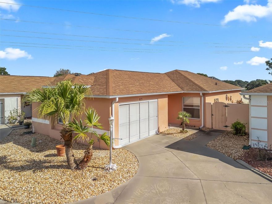 Discover your private retreat in this beautifully maintained 2-bedroom, 2-bath Courtyard Villa in the highly desirable Village of Villa La Palma—just steps from the De La Vista Golf Course, Tierra Del Sol Golf & Country Club, recreation center, and theater.
(Some photos are virtually staged). This inviting home features an open-concept layout filled with natural light and thoughtfully updated finishes throughout. Enjoy true peace of mind with new appliances (2024), new luxury vinyl plank flooring (2025), a newer roof (2020), HVAC (2018), and hot water heater (2020).
Step outside to your private courtyard oasis, where a glass-enclosed lanai opens to a spa-style swim pool with jets, all set on a brand-new patio surface (2025)—the perfect space for exercise, relaxation, or entertaining while enjoying the Florida breeze and natural light.
Additional highlights include a 1.5-car garage with room for a golf cart and extra storage, along with low-maintenance landscaping ideal for year-round living.
With no neighbors behind, you’ll enjoy serene views of the natural wildlife area adjacent to the De La Vista Golf Course—a rare combination of privacy, tranquility, and a true connection to nature.
This villa combines comfort, style, and The Villages lifestyle—golf, recreation, and relaxation right at your doorstep.