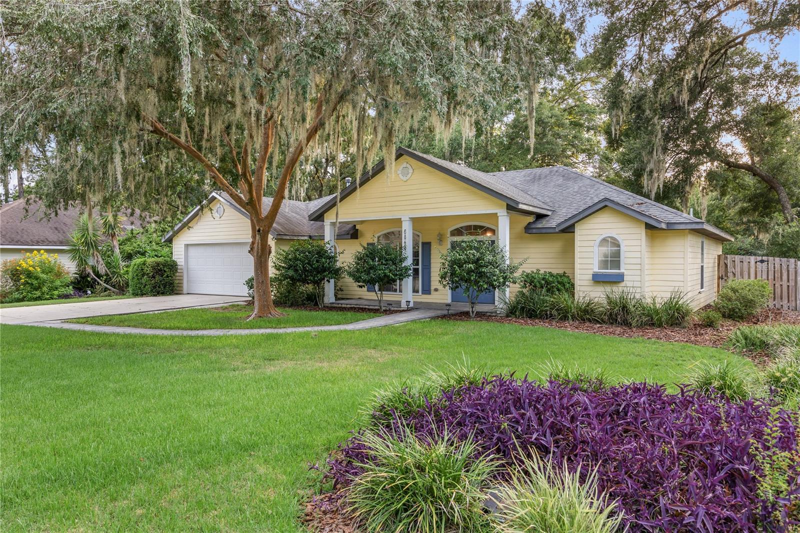 One or more photo(s) has been virtually staged. Tucked away on a quiet cul-de-sac in the highly sought-after Mentone subdivision, this beautifully maintained 3-bedroom, 2-bathroom home with a flex den offers the perfect balance of privacy, comfort, and convenience. The welcoming front entry features a covered porch and paver walkway that leads from the driveway to the front patio and entryway, setting the tone for what awaits inside.
Step inside and enjoy a thoughtfully designed split floor plan filled with natural light and timeless features. A traditional dining room and formal living room provide a warm and inviting space for entertaining, while the spacious kitchen includes an eat-in breakfast nook and overlooks the large great room with vaulted ceilings — the heart of the home for everyday living and gatherings. The primary suite offers a private retreat, complete with an attached den and private access to the back screened porch. The ensuite bathroom has been beautifully renovated and features a granite double vanity, jacuzzi soaking tub, walk-in shower, and a generous walk-in closet. On the opposite side of the home, bedrooms two and three share a second full bathroom, creating a comfortable setup for family or guests. A large laundry room with cabinetry and folding tables adds everyday convenience, and the two-car garage offers plenty of storage space.
This home truly shines outdoors, where multiple living and entertaining spaces invite you to relax and enjoy the Florida lifestyle. A screened-in lanai with paver flooring and a ceiling fan provides year-round comfort, while the expansive composite deck flows seamlessly into the backyard. A curved paver walkway leads to a spacious patio with a raised stone planter, perfect for outdoor dining, cozy firepit nights, or weekend gatherings. The fully fenced yard is thoughtfully landscaped with low-maintenance greenery and mature trees, creating both privacy and a sense of tranquility.
Living in Mentone means more than just owning a beautiful home — it’s about enjoying a community lifestyle. Residents have access to a large resort-style swimming pool, tennis and basketball courts, a playground, open green spaces, and a clubhouse for events and gatherings.
Perfectly situated in Southwest Gainesville, this home offers unmatched convenience to everything you need. You’re just minutes from UF Health Shands Hospital, the Malcom Randall VA Medical Center, and HCA North Florida Hospital. Popular shopping and dining destinations like Celebration Pointe, Butler Plaza, and charming Haile Village are right around the corner, and the nearby I-75 on-ramp makes commuting simple and stress-free.
This home offers the perfect combination of functional living, outdoor enjoyment, and community lifestyle — all in one of Gainesville’s most desirable neighborhoods.