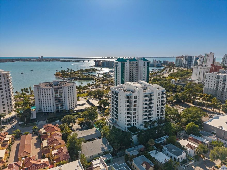 Welcome to the premier offering at the Savoy—an extraordinary, one-of-a-kind penthouse with sweeping Sarasota Bay views, set along coveted, tree-lined South Palm Avenue and rising 11 stories above downtown, where elevated design meets refined living. Fully renovated and expertly designed by the current owner, this remarkable 4,385 sf home offers 4 private terraces and an unmatched indoor-outdoor living experience, all enhanced by seamless smart home integration. From the moment you arrive at your private elevator foyer, you are welcomed by custom glass double doors with genuine leather handles, set against a striking backdrop for the owner’s curated Chihuly glass collection. At the heart of the residence, the chef's kitchen is both striking and functional, appointed with Poggenpohl push-and-pull cabinetry, Wolf double ovens, Subzero refrigerator, Miele induction cooktop with gas burner, Miele hood, an impressive 5-inch granite island with breakfast bar, a matching granite dining table, and beautiful bar with Subzero wine refrigerator. Imported Italian porcelain tile flows throughout, creating a cohesive and sophisticated backdrop for everyday living and entertaining. Rich suede finishes, bespoke lighting throughout, custom wall coverings, and expansive walls of glass define the interiors, bathing the home in natural light while framing breathtaking panoramic Bay and City views from every angle. Designed for effortless entertaining, the top-level expansive newly tiled terrace is the perfect spot for cooking on your gas grill and enjoying all fresco dining and the sweeping skyline vistas. The serene and spacious primary suite features a spa-like bath with his and her vanities with integrated smart mirror TV displays, custom mosaic tile, tile and glass shower, and free-form 2 person Jacuzzi tub with air jets where you can relax and take in the incredible view. Guests enjoy a private and sumptuous guest suite with en-suite bath which easily functions as a second primary suite. The 3rd bedroom is currently used as an office with high-end custom built-ins perfect for productivity. The spacious living and family rooms both feature media centers with rich piano-gloss wood paneling. The smart-home residence features modern conveniences which elevate daily living such as custom walk-in closets with sensor-activated lighting, integrated motorized window treatments, automatic lighting and whole home Sonos audio, and is equipped with three A/C units, new digital Essency water heater, and Aquasana whole house water filtration system, ensuring comfort and peace of mind. Rare private 3 car garage with EV charger with 1 section that has been enclosed and air conditioned. Residents of the 24-unit Savoy enjoy an array of upscale amenities, including heated lap pool and spa, concierge and full time on-site manager, guest suite, towel service, locker rooms with sauna, a dog run, grilling area and catering kitchen, building water softener, secure parking, and elegant gathering spaces designed for hosting and connection. Located just steps from Sarasota's Main Street, Burns Court, the Bayfront, and Selby Gardens, this exceptional penthouse offering simply cannot be replicated.