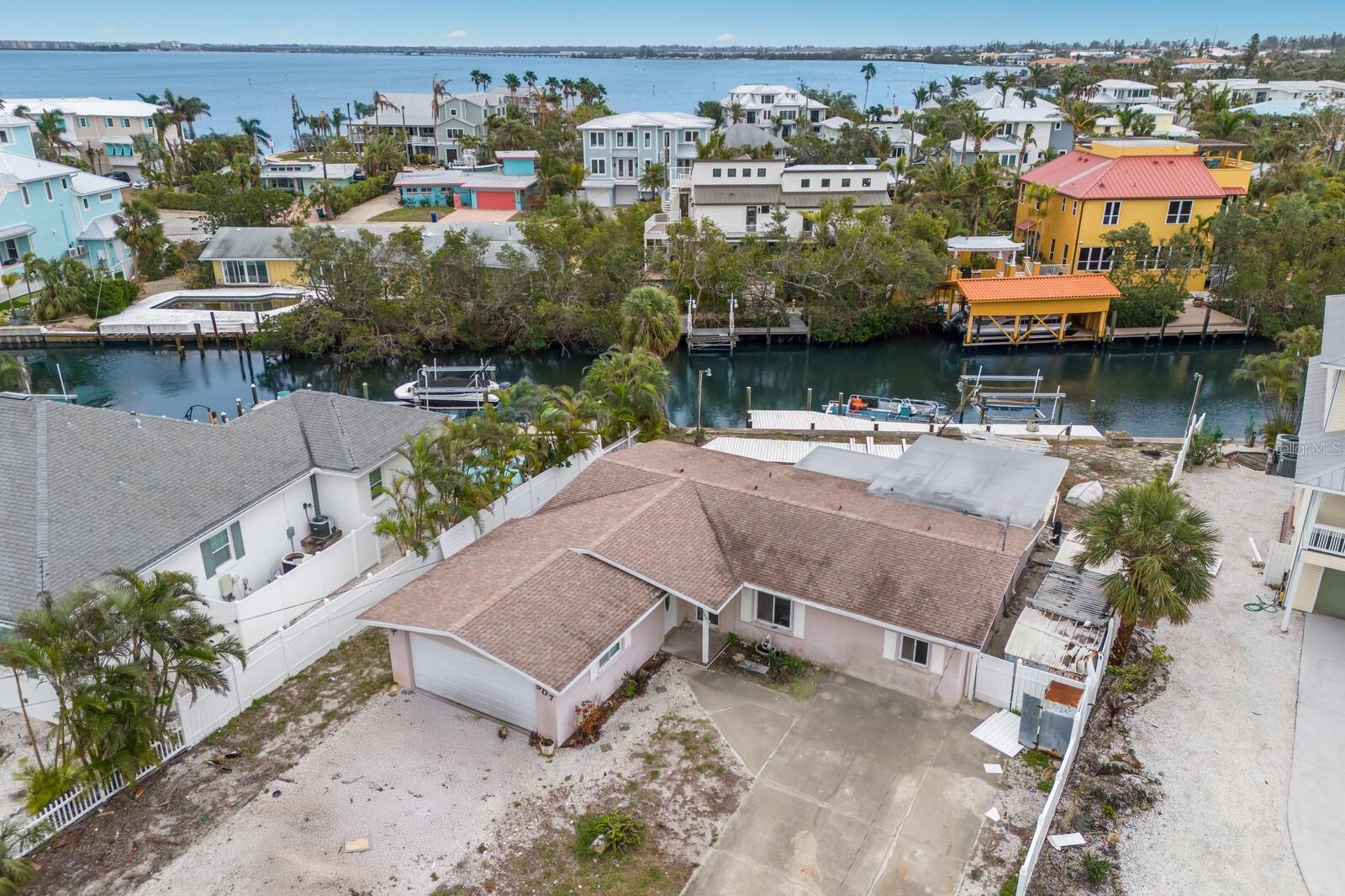 This 3BD/3BA waterfront home in Holmes Beach offers an incredible opportunity for those looking to bring their vision to life. With an open floor plan, two ensuite bedrooms, a private dock for easy boating access, and a pool for enjoying the Florida sunshine, it’s a fantastic choice for those seeking the island lifestyle. While the home has sustained storm damage and will need repairs, the prime location and spacious lot provide plenty of potential for a full renovation or a brand-new build. Whether you choose to restore or start fresh, this property offers endless possibilities on the beautiful Anna Maria Island, known for its stunning beaches, relaxed coastal vibe, and monthly rental potential—an excellent chance to create your dream coastal escape.