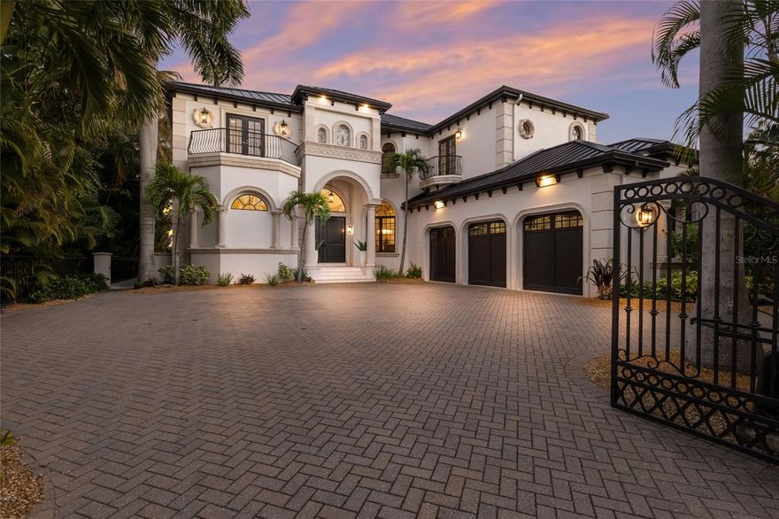 Discover refined living and tranquility in this stunning home set within the esteemed Lido Shores neighborhood. Step inside through striking Sapele entry doors into a thoughtfully remodeled residence by award-winning Mindy Webb Design. The instant you enter, you're greeted by a breathtaking wall of windows that highlights the infinity pool, sweeping views of Sarasota Bay, the city skyline, and the impressive John Ringling Bridge. Inside, a contemporary color palette and premium finishes elevate every room. The spacious five-bedroom estate reveals meticulous craftsmanship throughout, with Italian flooring, a gourmet chef’s kitchen, butler’s pantry, billiard room, two wet bars, a climate-controlled wine cellar holding up to 648 bottles, intricate crown molding, tray ceilings, an office/den with embossed copper ceiling, and a two-stop elevator. The master suite, on the main floor, includes dual, custom walk-in closets and a spa-like bathroom. An extraordinary collection of chandeliers throughout the home adds a touch of elegance. Three of the additional en-suite bedrooms provide comfort for guests or family, the show-stopping wine cellar , with new cooler, will delight any enthusiast. Start your mornings peacefully, taking in the kaleidoscope of hues as the sun rises over the bay, watch dolphins and manatees glide by. Relax at night beside a fire on the upper balcony, enjoying views of the glowing Ringling Bridge and Sarasota skyline. Outdoor features include a summer kitchen, two separate dining spaces, a 16,000 lb. boat lift capable of accommodating deep-hulled vessels, two Jet Ski lifts, a dedicated kayak/paddle boat platform measuring 9 feet by 14 feet with an integrated rack, as well as an additional dock platform sized at 16 feet by 9 feet.  Sustainable updates abound, like 51 new solar panels paired with three Tesla storage batteries. Additional features: four-zone Trane air system, fenced yard, brand-new metal roof (2025). The professionally landscaped grounds feature native Florida foliage, palm trees, and ambient lighting for evening gatherings. Furniture available via separate contract.
End your day with a stroll along your community-private beach. Lido Shores Association membership is voluntary ($500/year) for access to a private gated beach, pavilion, Bocci Ball Court, and many community events. This home has been expertly renovated and meticulously maintained—simply bring your suitcase and move right in!  
Located minutes from boutique shopping, fine dining, cultural venues, and St. Armands Circle, residents also enjoy proximity to world-class golf courses and recreational parks. The residence promises both privacy and community, offering a tranquil retreat while being close to Sarasota's vibrant coastal lifestyle.