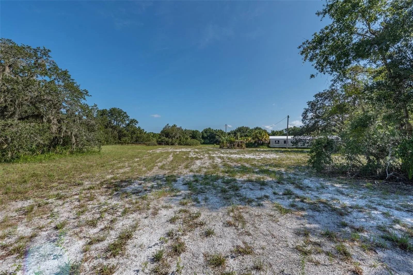 Acreage with many possibilities. Two Folio #'s together make up an almost 6-acre parcel. Easement to the property included. 1 Septic, 1 well, 1 electric pole with a meter, 2nd electrical pole has no meter. Two Older manufactured homes one possibly with a title other has no title. May be able to save on impact fees to build a new home. Special RSB Zoning is a plus ample space to store Boats, Trucks, RV's etc... Convenient location to I-75, nearby shopping, restaurants, Hospitals and a fairly new YMCA. Buyer to verify room dimensions.
