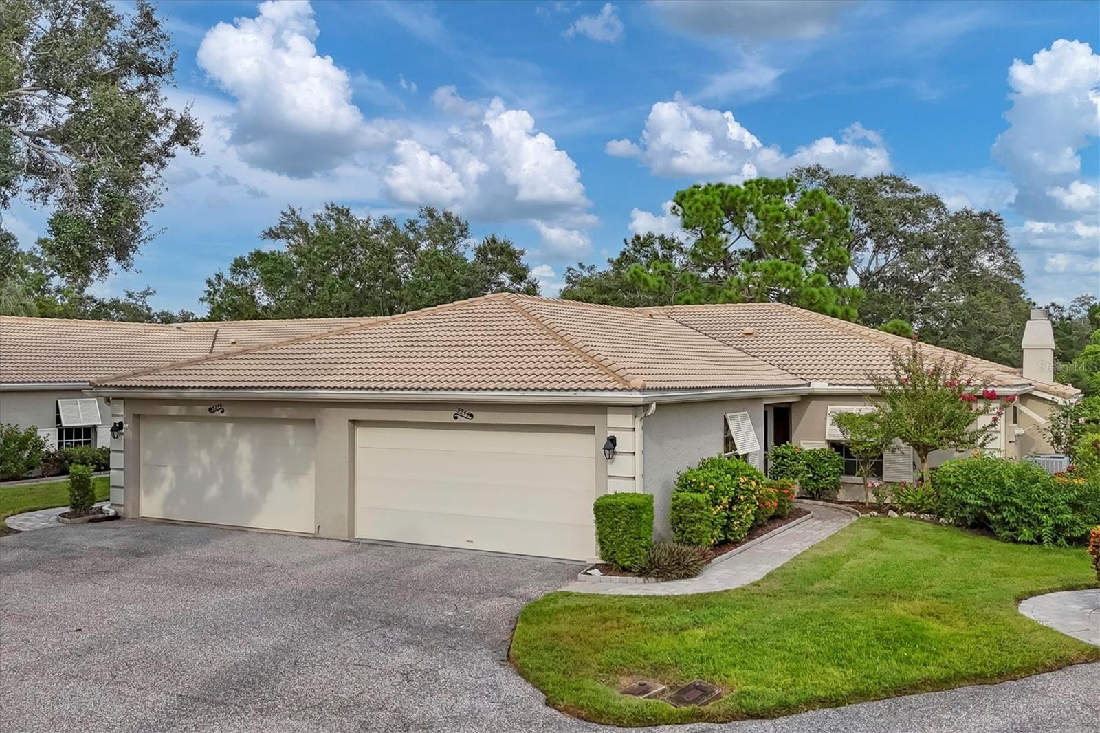 Lovely location on a cul-de-sac of swaying palms, Papillon consists of private enclaves of maintenance free-villas in The Meadows. You will be greeted by a paver sidewalk leading to the front entry with sidelight. Upon entry, wood flooring from the living room and dining room flow to form a cohesive foundation. The kitchen has a breakfast nook or space for cozy family dining. The living room with high ceilings leads to a wall of sliders opening onto a spacious glassed-in lanai offering you gorgeous water views framed by mossy Live Oak trees. The lanai floor was raised to allow flow from the living room and expands the living space and peaceful views. A fireplace with convenient electric insert provides ambiance on those cooler evenings. The spacious primary bedroom features an ensuite bathroom featuring split dual sinks, shower/tub combo, and ample walk-in closet. The guest bedroom is large and just steps away from the guest bathroom with shower/tub combo. A laundry closet houses the full-size washer and dryer and extra storage. Two car garage with extra depth for storage or workbench space and water heater 2017. Peace of mind with block construction and new tile roof 2012, exterior painted, new downspouts and window shutters, HVAC 2017. Above flood plain in zone x. Enjoy the most delightful resort-style heated community pool just steps away on its own private island for a quick dip or meet neighbors for an outdoor happy hour. Walk to The Meadows Shopping Village for restaurants, a new neighborhood pub, hair salon, massage therapist, and other convenient services. Papillon HOA has fully-funded reserves and takes pride in a well-managed neighborhood. Live in a friendly and very active community with 24 hour safety patrol and enjoy the carefree Florida lifestyle! The Meadows offers 54 holes of golf, a highly regarded tennis complex with 15 lighted Har-Tru courts, Jr. Olympic swimming pool with spa, private dog park, basketball, new fitness center, and 10 new pickleball courts. All located within 1,650 acres of tropical mature landscaping with miles of trails, wildlife preserves and over 80 lakes and ponds, while convenient to all that Sarasota offers! Minutes to luxury shopping and dining at UTC Mall, Mote SEA, Nathan Benderson Park for water sports and miles of recreational opportunities, downtown Sarasota for art and cultural activities and world class Gulf beaches.