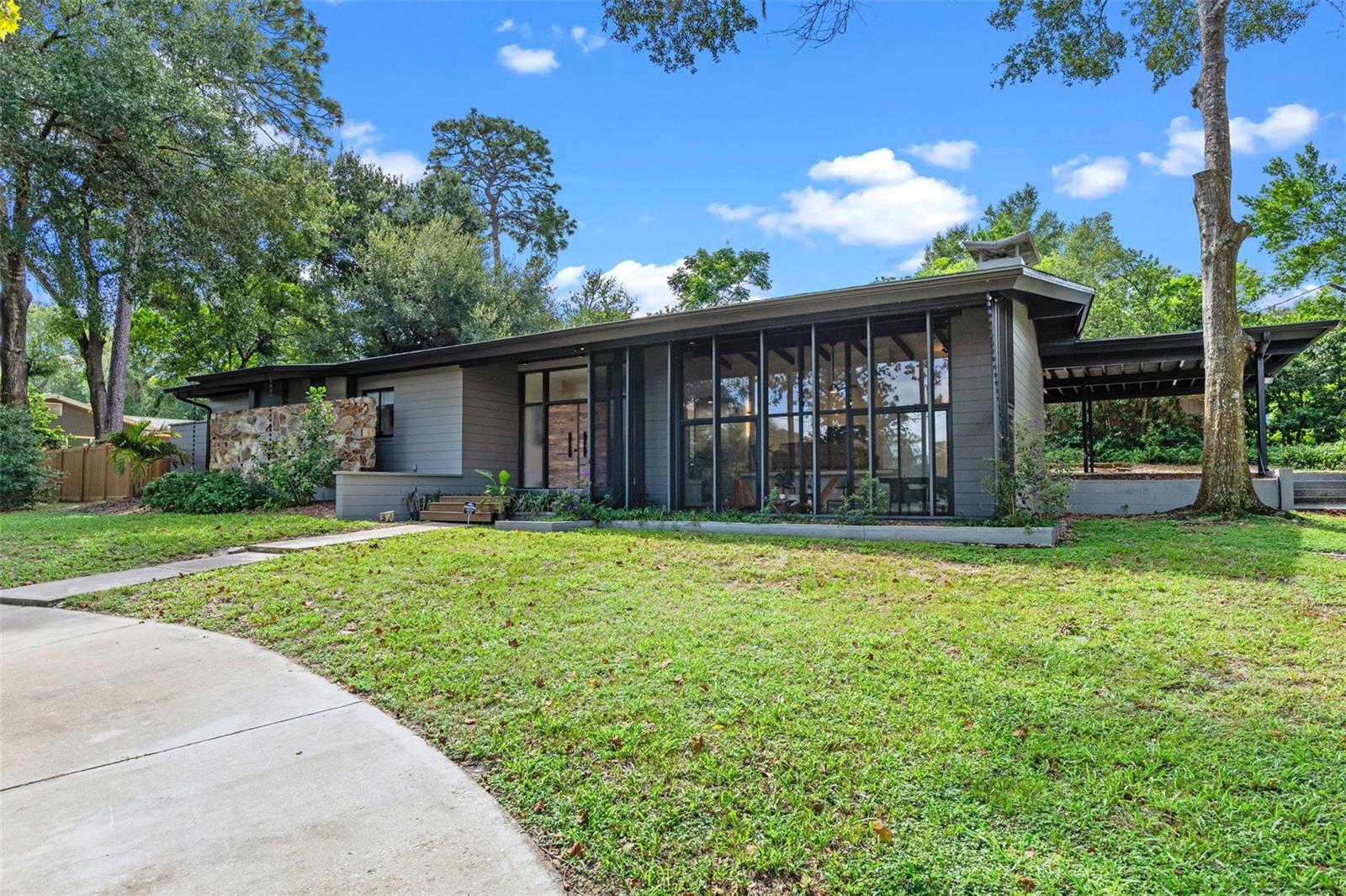 Welcome to your dream oasis in the sought-after Sanlando Springs community of Longwood, Florida — just minutes from Winter Park and an easy drive to downtown Orlando! This stunning, single-story home exudes mid-century modern charm and has been thoughtfully remodeled to provide a luxurious living experience on a rare double corner lot. Constructed of solid concrete block, this residence offers durability and timeless quality.
Spanning 2,337 square feet, the home features three spacious bedrooms and two and a half baths. Designed for those who love both indoor and outdoor living, the home is graced with large windows and glass doors that flood the interior with natural light. The striking cathedral ceiling adorned with exposed wood beams pairs beautifully with a cozy wood-burning brick fireplace, creating a dramatic yet inviting living space. Outside, you’ll find a fenced yard complete with an RV hookup, RV parking, and two driveways, offering ample parking for over eight vehicles. The unique multi-level design allows for an interior garden and abundant indoor and outdoor storage. Picture yourself unwinding to a serene water view or cultivating your own veggie patch, also included in this expansive setting.
Functionality meets style with a whole-home water softener and filtration system. Enjoy flexibility with short-term rental options, adding value and versatility to your investment. The primary suite offers generous space, while additional areas are perfect for a home office or creative workspace. With no HOA, this Longwood home is a standout choice for those seeking a perfect blend of tranquility, modern comforts, and income potential.
Nestled in the vibrant community of Sanlando Springs in Longwood, this location offers a perfect blend of convenience and recreation within a 50-mile radius. Shopping and food enthusiasts will enjoy the Altamonte Mall alongside the extensive dining options in the area. The AMC Altamonte Mall 18 movie theater will also make family outings a breeze. Outdoor lovers will appreciate easy access to Wekiva Springs and Rock Springs for hiking, kayaking, and wildlife encounters. The historic town of Sanford, with its picturesque riverwalk, zoo, and eclectic dining scene, lies just a short drive away. You’re also just minutes from Winter Park’s renowned Park Avenue shopping and dining district, and a short drive to all the culture, entertainment, and employment opportunities of downtown Orlando.
Healthcare facilities like AdventHealth Altamonte Springs and Orlando Health South Seminole Hospital provide peace of mind. With top-notch schools and an exceptional quality of life, Longwood is an ideal place to call home.