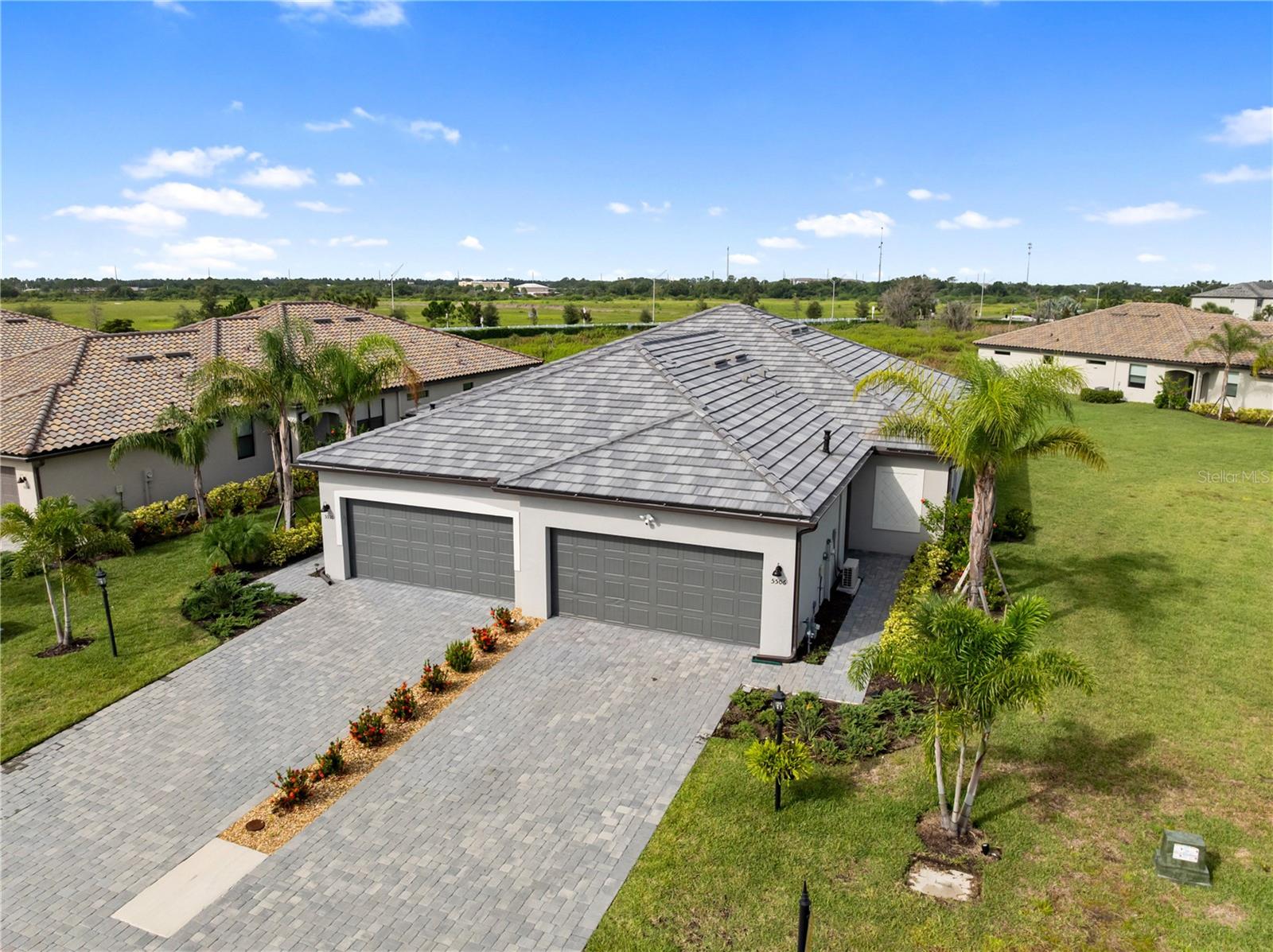 Experience Florida living at its finest in this beautiful newly built 2023 construction villa located in the resort-style community of Lorraine Lakes in Lakewood Ranch. This 3-bedroom, 2-bath home features a smart, open layout with modern finishes and quality craftsmanship throughout. Inside, you'll find tile flooring in the main living areas, carpet in the bedrooms, hurricane impact windows, and a bright open-concept design that connects the kitchen, living, and dining spaces. The kitchen offers granite countertops, stainless steel appliances, a spacious pantry, and ample cabinet storage—perfect for daily living and entertaining. The private primary suite includes a walk-in closet, dual vanities, and a large walk-in shower. Two additional bedrooms provide flexibility for guests, a home office, or additional living space. A well-equipped laundry room includes built-in cabinetry, and the two-car garage features an epoxy-coated floor, built-in shelving for organized storage, and its own A/C unit to keep you cool while working or relaxing in the space. Step outside to the screened-in lanai and enjoy peaceful views surrounded by lush landscaping. As a resident of Lorraine Lakes, you’ll have access to world-class amenities including a resort-style pool, clubhouse, state-of-the-art fitness center, on-site restaurant and bar, tennis and pickleball courts, and more. Conveniently located near Lakewood Ranch’s top shopping, dining, golf courses, and Gulf Coast beaches, this newly built 2023 construction villa offers the perfect blend of luxury, lifestyle, and location. Schedule your private showing today and make this exceptional home yours!