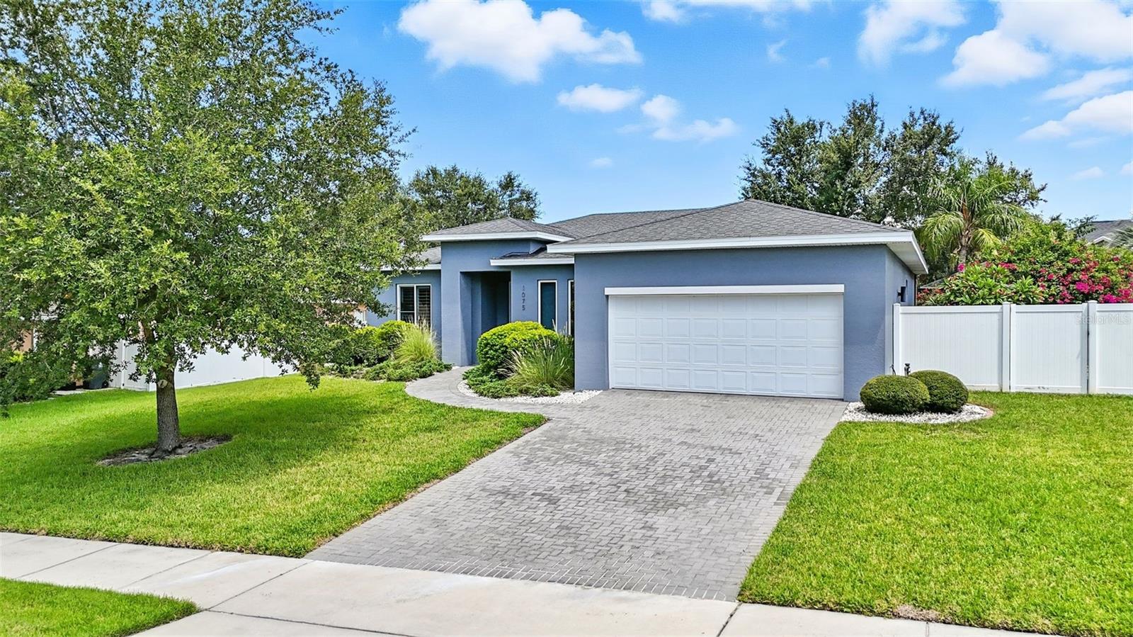 Welcome to 1075 Chase Drive-located in downtown Winter Garden, just minutes from the charm and energy of Plant Street. This rare, newer-construction single-story home offers a blend of modern comfort and timeless style that’s sure to impress. As you enter, custom tile in the foyer sets the tone, with a versatile flex room to the right—perfect for a home office, formal dining room, playroom, or whatever suits your lifestyle.The open-concept design seamlessly connects the kitchen, dining, and family areas, creating an ideal space for entertaining. The large kitchen island is perfect for cooking, casual meals, or hosting friends and family. Sliding glass doors open to create an effortless indoor-outdoor living experience—perfect for those quintessential Florida days. The split floor plan offers privacy, with the primary suite serving as a true retreat, complete with high ceilings, a double vanity, and a spa-like shower. On the opposite side of the home, you’ll find three additional spacious bedrooms, each with plantation shutters and high end laminate flooring.
After a long day, unwind on your fully screened back porch with space for multiple seating areas, or head to the side yard to tend your garden. The thoughtfully designed outdoor living space offers plenty of room for grilling, dining, and relaxing—an entertainer’s dream.
Just minutes from your front door, Winter Garden’s vibrant Plant Street awaits, offering an award-winning farmer’s market, local dining, boutique shopping, art galleries, Crooked Can Brewery, the West Orange Trail, and year-round festivals.This is a rare opportunity to own a beautifully crafted home in one of Winter Garden’s most desirable neighborhoods—where modern living meets small-town charm. Call for your private showing today.