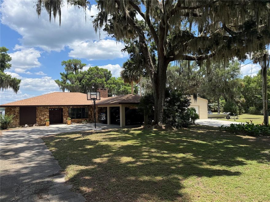 Experience true waterfront living on the shores of beautiful Lake Panasoffkee in this stunning 4 bedroom 3 bath pool home situated on nearly an acre with approximately 300 feet of lake frontage. Tucked away at the end of a paved county road, this private retreat offers panoramic views, peaceful surroundings, and exceptional indoor-outdoor living. Designed for both comfort and entertaining, the home features wood and tile flooring throughout, and spacious layout with both a living room and family room. The oversized owner's suite provides a relaxing escape, while the additional bedrooms offer generous space for family and guests. The kitchen is equipped with all stainless steel appliances, solid wood cabinetry, and quartz countertops and opens seamlessly to the home's expansive entertaining areas. Outside you can enjoy the pool with screen enclosure and fully equipped outdoor kitchen with concrete countertops, stainless steel grills, sink, and ice makers all perfectly positioned to enjoy breathtaking lake views. For boating and outdoor enthusiasts, the property includes a private dock and covered boat slip on Lake Panasoffkee. A massive 30x25 garage/workshop provides excellent space for hobbies, storage, or recreational equipment. The paved four-board/wire fencing, and dual automatic gates add both functionality and curb appeal. Located in a quiet neighborhood a short distance from The Villages where you can find dinning, shopping, and nightly entertainment. For those needing to commute Interstate 75 and The Florida Turnpike are just a hop, skip, and a jump away. Schedule your private showing today and begin your journey to experiencing the ultimate Florida lifestyle.