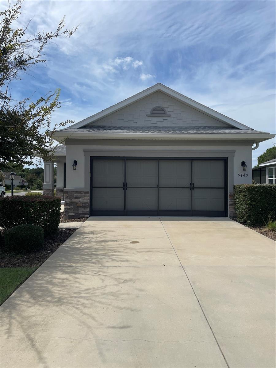 This beautifully maintained Oren model sits on a desirable corner lot in the sought-after Windsor West neighborhood. Designed with entertaining in mind, the open floor plan features two spacious bedrooms, two full bathrooms, and a two-car garage. The home is decorated in neutral tones, with tile flooring throughout the main living areas and newly installed carpet in the bedrooms. The glass-enclosed lanai provides additional living space to enjoy year-round.