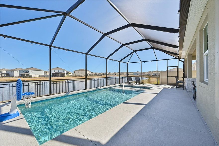 Welcome to your dream home at 10516 Chippewa Dr., nestled in the picturesque community of Bella Lago in Parrish, Florida. This stunning single-family residence, built in 2022, boasts a spacious 2045 square feet of contemporary living space, featuring Three bedrooms with a Flex/Office Space with French Doors and 2.5 baths. With an inviting curb appeal and a meticulously designed layout, this home is perfect for families seeking comfort and style in a vibrant neighborhood.

As you step through the front door, you are greeted by an open floor plan that seamlessly blends the living, dining, and kitchen areas, creating an ideal setting for entertaining and family gatherings. The heart of the home showcases a modern kitchen adorned with elegant backsplash details, pendant lighting, and under-cabinet lighting that highlights the high-end finishes. The adjacent laundry room features custom upgrades, ensuring functionality meets style.

The real jewel of this property is the exquisite outdoor living space. Step outside to discover your own personal oasis—a luxurious saltwater pool enclosed by a protective cage. This heated and chilled pool is equipped with an inground cleaning system that ensures crystal-clear waters without any cold spots, making it a perfect retreat for year-round enjoyment. Whether you're hosting summer barbecues or enjoying quiet evenings under the stars, the custom high-end designed luxury outdoor kitchen, will impress your guests with its high-end features and ample space for culinary adventures.

The backyard offers breathtaking views of a serene pond, providing a tranquil backdrop while you unwind or entertain. With a low-maintenance yard and extra insulation in both the attic and garage, this home is designed for comfort and efficiency. The insulated garage door and above-storage ensure practicality, while custom blackout blinds in the bedrooms and motorized blinds on the sliding doors add a touch of luxury.

Living in Bella Lago means embracing a vibrant lifestyle filled with amenities that cater to both relaxation and recreation. Residents enjoy access to a stunning clubhouse, a resort-style heated swimming pool, and a fully equipped fitness center. Children can play and make memories at the tot lot, while pet owners will appreciate the dedicated dog park. With a multi-purpose sports field and a covered picnic area, this community fosters a sense of connection among neighbors and offers plenty of opportunities for outdoor fun.

In addition to its remarkable features, this home is situated in a conservation area, ensuring privacy and a natural setting right outside your door. The front yard irrigation system utilizing community reclaimed water is an eco-friendly touch that aligns with a sustainable lifestyle.

In conclusion, 10516 Chippewa Dr. offers a rare opportunity to own a luxurious, upgraded home in the heart of the sought-after Bella Lago community. With its stunning outdoor features, modern amenities, and family-friendly environment, this property is not just a house; it's a place where memories are made and cherished. Don’t miss your chance to experience the best of Parrish living—schedule your tour today!