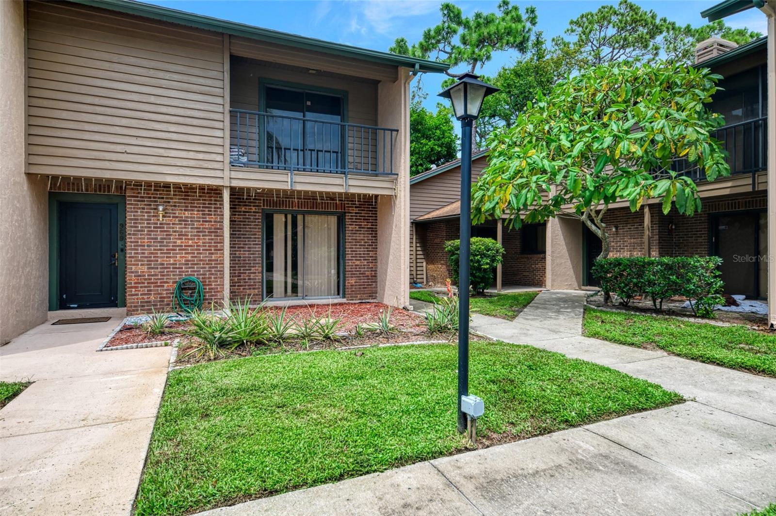Enjoy easy one-floor living in this spacious 3-bedroom, 2.5-bath condo in the desirable Sunridge community! Bathed in natural light, the bright, airy layout flows into an open living/dining area anchored by a classic wood-burning fireplace. The well-appointed kitchen offers ample storage and a convenient breakfast bar, while generously sized bedrooms provide comfort and flexibility for guests or a home office. A private rear lanai extends your living space—perfect for morning coffee or evening gatherings. Enjoy community amenities including a sparkling pool, plus maintenance-free exterior and landscaping. A rare blend of comfort, space, and convenience in a prime Sarasota location.