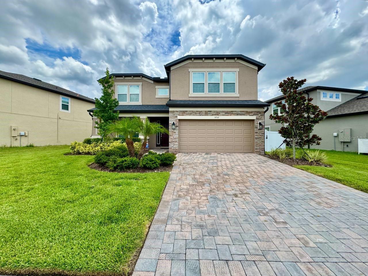 Welcome to this beautiful 5-bedroom, 3-bathroom home with a 2-car garage in the highly desirable Chapel Crossings community of Wesley Chapel. With wood laminate flooring throughout, high ceilings, and an open, airy floorplan, this home offers the perfect blend of comfort, style, and functionality. The chefs kitchen is the heart of the home, featuring stainless steel appliances, granite countertops, an expansive kitchen island, and abundant cabinetry ideal for cooking, entertaining, or enjoying a quiet family meal. Upstairs, a spacious loft provides flexible living space perfect for a media room, play area, or game room. The primary suite is a true retreat, complete with an en-suite bath featuring dual sinks, a large garden soaking tub, and a walk-in shower for ultimate relaxation. For your convenience, the washer and dryer are included. Step outside to the screened-in patio, perfect for morning coffee or evening gatherings, overlooking a large, fenced-in backyard ideal for pets, play, or entertaining. Enjoy resort-style living with community amenities that include a stunning pool, playground, and fitness center. All this, plus a prime location close to major highways, shopping, dining, and top-rated schools. Don't miss the opportunity to live in one of Wesley Chapels most sought-after communities schedule your showing today! Please note, a 700 credit score or higher is required. In addition to the advertised base rent, all residents are enrolled in the Resident Benefits Package (RBP) for $50.00/month which includes HVAC air filter delivery, credit building to help boost your credit score with timely rent payments, utility concierge service making utility connection a breeze during your move-in, and much more! More details upon application. One pet welcome, 35 lb max. Vacant and Available now! This property does have a water softener and filtration system that will have initial supplies provided upon move-in, tenant responsibility throughout the lease. This property also has no rear facing neighbors as this property is pond view.