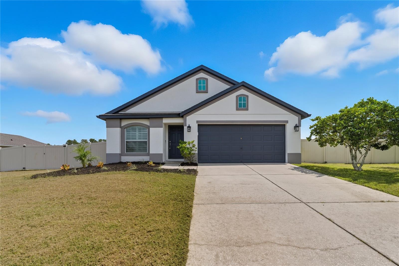 Welcome to 12410 Loopback Drive. This Inland Homes Rosewood model offers 3 bedrooms, 2 baths, and a versatile den/office—beautifully maintained by its original owner with thoughtful updates throughout. Step inside to vaulted ceilings and custom plantation shutters that create an open, inviting feel. The kitchen is the heart of the home with granite counters, a raised bar top, and a custom extended coffee bar with extra storage—a feature unique to this Rosewood model. The primary suite provides a private retreat with dual vanities, a soaking tub, and a separate shower. Two additional bedrooms plus the den/office provide flexibility for guests, work, or hobbies. The sunroom addition expands the living space, while the fully fenced backyard delivers privacy and plenty of options—with room for a pool, boat storage, and/or an outbuilding such as a shed or in-law suite (per HOA/city guidelines). Recent updates per seller include exterior paint (2023), water heater replacement with 10-year warranty (2022), septic system service with new leech field (2023), and lift station pump replacement (2024). A Tesla Level 2 charger will convey and landscaping service is already paid through the end of the year. Built with durability in mind, this home includes hurricane strapping, poured lintels, radiant attic sheathing, and an in-wall termite treatment system with a 20-year builder-applied warranty (per seller; buyer to confirm transferability). Located in the charming town of San Antonio with its local shops, dining, and community feel, this home also offers quick access to I-75, Publix, the Mirada Lagoon, and all that nearby towns like Dade City and Wesley Chapel have to offer.