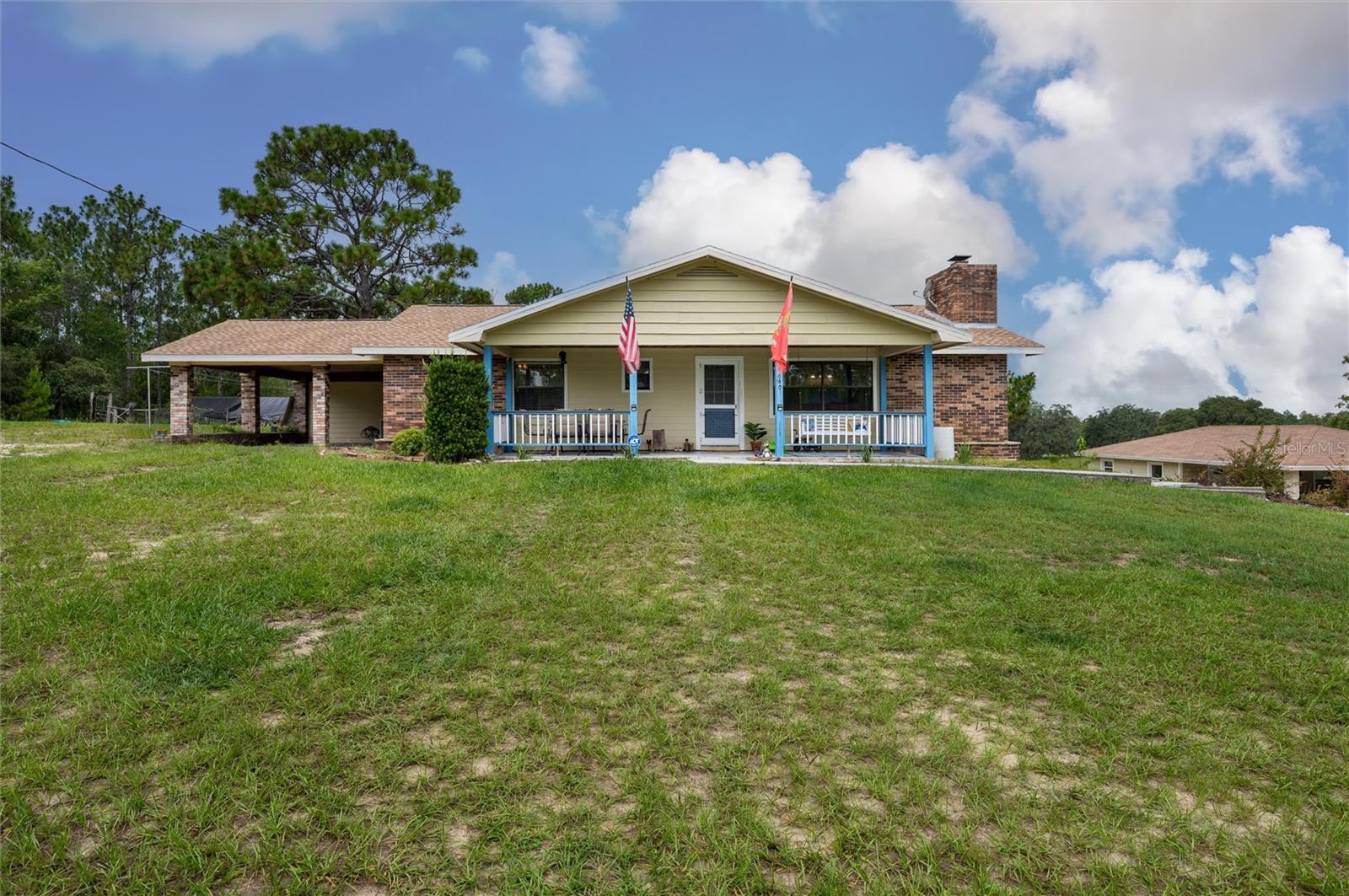 Embrace the charm of country living with this beautifully updated 3-bedroom, 2-bath, bonus room, single-family residence, nestled on 5 serene acres in the heart of Dunnellon’s picturesque farmland.
Perfectly situated in Citrus County, this peaceful retreat offers convenient access to downtown, lush state forests, and miles of scenic trail riding. Set atop a gentle hill, the home boasts a welcoming front porch—ideal for quiet mornings—and a cozy wood-burning fireplace that invites relaxation on cool evenings.
Crafted with character, the interior features solid pine doors and cabinetry, a spacious kitchen, formal living and dining rooms, and a generous family room, all enhanced by warm wood and luxury vinyl plank flooring. The expansive primary suite offers ample closet space and peaceful views of the surrounding landscape.
Step out to the rear porch and enjoy sweeping vistas of rolling pastures and open skies. Additional highlights include a new roof, an oversized garage, and a detached two-bay carport with an air-conditioned 576 sq. ft. bonus room—ideal for a guest suite, gym, home theater, or in-law quarters.
Thoughtfully upgraded for comfort and functionality, the home includes a new whole-house reverse osmosis water filtration system, a recently cleaned-up septic tank, new toilets and ceiling fans, and a state-of-the-art digital security system with cameras and sensors. Recent improvements also include the removal of all carpeting, replaced with elegant luxury vinyl flooring throughout the bedrooms.
A chicken coop with full amenities awaits the farm enthusiast, and agricultural exemptions may apply, adding value for those seeking a more self-sustained lifestyle.
This solid block-and-brick home offers a rare blend of tranquility, comfort, and natural beauty—an ideal haven for those longing to escape the city’s hustle and embrace the whispering winds of Florida’s majestic pines and oak trees.