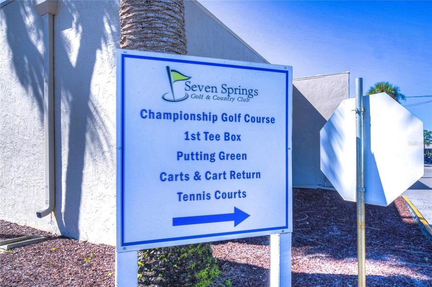 Seven Springs Golf and Country Club in New Port Richey, Florida, With a dual 18-hole golf course: the demanding Championship course and the executive-length Challenger course. It offers a variety of amenities beyond golf, including a clubhouse with dining, multiple pools, fitness rooms, and courts for tennis, pickleball, and bocce ball. The club is also a popular venue for events and weddings. Close to Airports and beaches. This 2/2/1 car garage  has a great view of the golf course, 4th Tee, and a pond view. There is a family room and screened in lanai with picturesque views. The unit is a split plan unit with 2 baths. It has a seperate eat in kitchen and breakfast bar. All appliances convey. Newer A/C and water heater. Close to the clubhouse for easy access to the amentities. No Flood Insurance Required