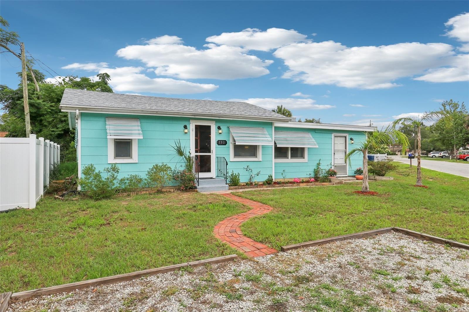 Welcome to 1301 North Avenue—a stylishly preserved mid-century cottage that perfectly blends vintage charm with modern updates. Nestled on a quiet street just one mile from the lively Tavares Entertainment District, this move-in-ready 2-bedroom, 1-bath home is full of character, flexibility, and the kind of Florida lifestyle buyers dream about. Step inside and you’ll be greeted by original hardwood floors, an abundance of natural light, and a flowing layout that feels both cozy and open. The kitchen is a true conversation starter, featuring a vintage aqua-blue stove, matching retro-style refrigerator and microwave, and tasteful updates that marry nostalgic style with everyday functionality. One of this home’s most versatile features is the oversized second bedroom—complete with a private exterior entrance, making it ideal for a guest suite, home office, or short-term rental. With its proximity to the utility room, there's even potential to add a second bathroom or create a full in-law suite, offering room to grow and boost long-term value. Recent updates deliver comfort and efficiency: 2020 Roof, 2021 Mini-split AC systems (x3), 2021 Hot water heater. The private backyard is perfect for weekend gardening, entertaining friends, or simply enjoying a quiet escape outdoors. With no HOA and the ability to golf cart to nearby waterfront dining, live music, and year-round festivals, this home invites you to enjoy life at a slower pace—without sacrificing location. Just minutes from Downtown Mount Dora, AdventHealth Waterman Hospital, and an easy drive to Orlando-area attractions, this one-of-a-kind home is ready for its next chapter. Don't miss your chance to own this character-filled gem in one of Central Florida’s most vibrant small towns. Schedule your private tour today!