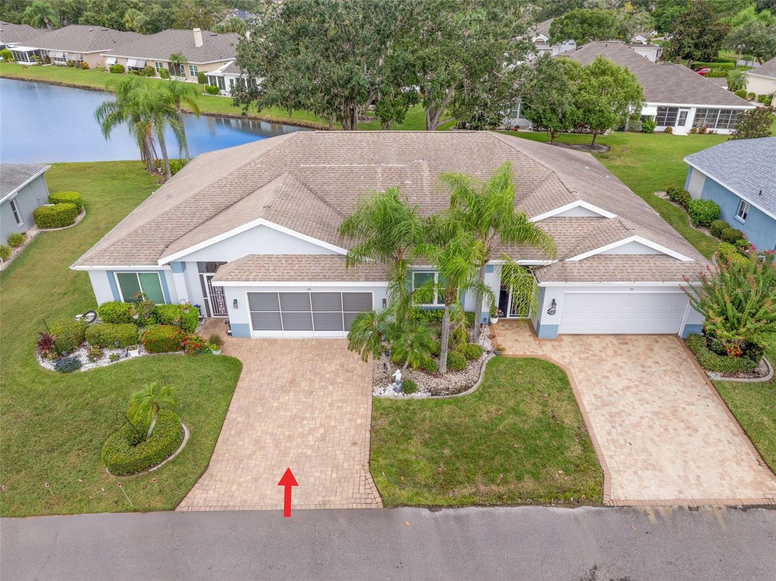 Experience PRIVACY and water views in this UPDATED condo located in the gated community of Kings Point! With resort-style amenities, you'll thrive in this golf cart-friendly 55+ location that offers a wealth of activities, including over 200 clubs to join, multiple indoor/outdoor heated pools, fitness facilities, pickleball, an onsite salon, restaurants, and much more! This sought-after Sandpiper split floor plan comes partially furnished and features 2 bedrooms, 2 full bathrooms, a Florida room, and a 2-car garage. Highlights include HURRICANE WINDOWS, cathedral ceilings, tile flooring throughout, and lots of natural light! An open concept has the living and dining spaces adjacent to the RENOVATED kitchen with Quartzite countertops, white shaker style cabinetry, an eat in space and a breakfast bar that caters to both everyday living and entertaining. The Florida room serves as your bonus area and offers serene views of water and wildlife, including a variety of birds! This versatile space has double pane windows and can be utilized as an office, exercise area, third bedroom, or even a craft room. Mature trees and landscaping enhance privacy, creating a perfect spot to unwind. Back inside, the primary bedroom is in the rear of the home and offers the same views and soaring ceilings!  The en-suite bathroom is thoughtfully designed for dual functionality, featuring a separate water closet and shower away from the vanity. You'll also enjoy a spacious walk-in closet that accommodates all your storage needs. The second bedroom is generously sized, easily fitting king-size furniture, and provides immediate access to the second full bathroom. The laundry is located INSIDE making this chore more enjoyable! Enjoy MAINTENANCE FREE LIVING that has an ON-SITE property management company and includes lawn care, pest control, water, sewer, trash and cable with 200 channels and internet! If you plan on venturing out there is quick access to restaurants, SHOPPING, beaches & 30 minutes to Tampa International Airport, less than an hour to the Sarasota shops and 20 minutes to Ellenton Prime Outlets!