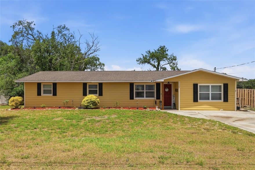 Welcome to this beautifully updated 4 bedroom 2 bathroom concrete block pool home offering 2,196 square feet of spacious living in the sought-after Hickory Hills community of Dade City. Step inside to a bright, open great room floor plan designed for both everyday living and entertaining. The updated kitchen is the heart of the home, featuring stainless steel appliances, solid wood cabinetry, granite countertops, and a stylish tiled backsplash that seamlessly flows into the dining and main living areas. Just off the dining room you’ll find a sunken family room filled with natural light, perfect for relaxing by the cozy wood-burning fireplace during the cooler months, or head out the sliding glass doors to your very own private outdoor retreat, complete with wraparound covered patios and a sparkling in-ground pool. The fenced backyard is thoughtfully landscaped and beautifully lit, this space is ideal for entertaining day or night all spring and summer long. Both the main and primary bathrooms have been tastefully updated with granite countertops, solid wood cabinets, and decorative ceramic tile finishes. A bonus feature that adds even more functionality to this home can be found just behind the custom sliding barn door across from the kitchen. Behind this door is a hidden hallway that leads to an oversized laundry room with plenty of functional space for hobbies and extra storage, along with the spacious fourth bedroom with picture windows, walk-in closet, and private entrance. This versatile space is perfect for guests, a home office, or potential in-law suite. This home truly has it all style, space, and the perfect setup for enjoying the Florida lifestyle. Schedule your private showing today!