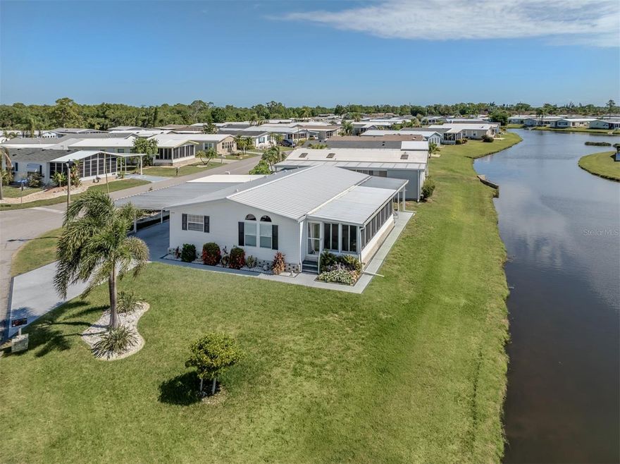 Welcome to waterfront living at its finest in the highly sought-after, land-owned, pet-friendly community of Harbor Isles! Perfectly positioned on one of the premier lots in the neighborhood, this spacious 2-bedroom home offers breathtaking, expansive views of two sparkling lakes, creating a peaceful backdrop from nearly every room.
Designed for both comfort and entertaining, the home features an oversized Florida room accessed through elegant French doors off the living room, where updated acrylic windows frame the spectacular water views and fill the space with natural light. Just beyond, a covered patio provides the perfect spot to relax, unwind, and enjoy the tranquil setting.
Inside, the generous living and dining areas offer an open, airy feel with vaulted ceilings, tile flooring, and more stunning lake views. The spacious kitchen is well-equipped with abundant cabinetry, ample counter space, and newer stainless steel appliances, all just one year old. Near the entry, a built-in office space provides a convenient area for work or hobbies.
Both large bedrooms offer walk-in closets, luxury vinyl flooring, and beautiful water views, creating comfortable private retreats. Additional features include inside laundry, a double-wide carport for extra parking, and a large double shed complete with a workbench and extensive storage space.
Important updates provide peace of mind, including a new metal roof (2025), replumbing (2021), and AC (2020).
Harbor Isles is one of the area’s most desirable manufactured home communities, offering a vibrant and active lifestyle with exceptional amenities including a marina with direct access to the Myakka River and Gulf of Mexico, a large clubhouse, heated pool and spa, fitness center, tennis and pickleball courts, bocce, shuffleboard, and a full calendar of social activities. Conveniently located near shopping, dining, golf, beaches, and historic downtown Venice, Harbor Isles offers the perfect blend of recreation, relaxation, and community living.