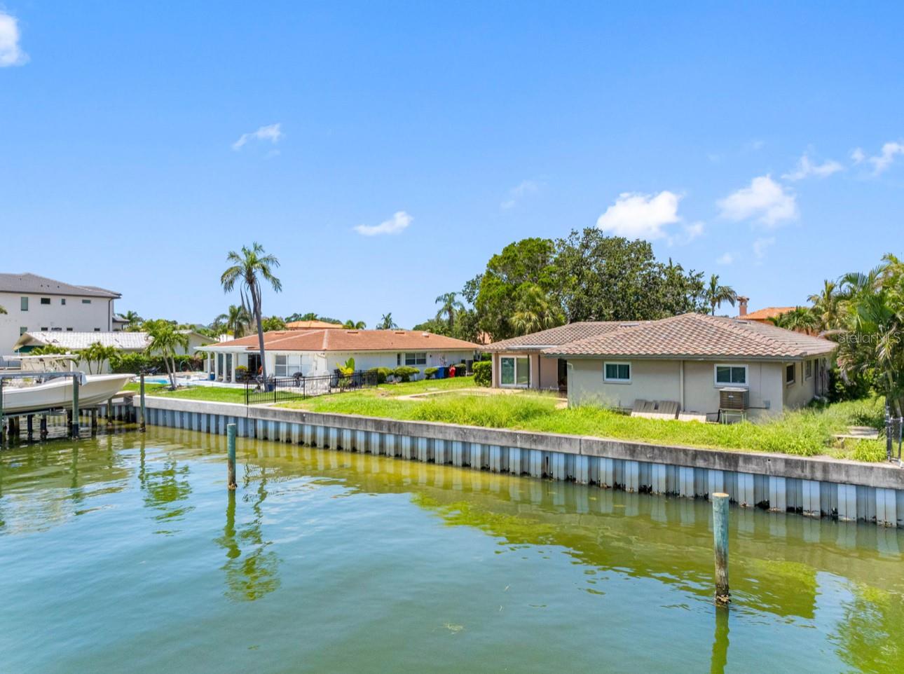 Welcome to 1962 Hawaii Ave NE – a rare chance to create your dream home in one of the most desirable waterfront neighborhoods in St. Petersburg. Situated on a spacious 10,224sqft lot with 91 linear feet of waterfront, this property offers direct access to open water with no fixed bridges – a boater’s paradise! The canals allow for sailboats and power boaters or both. Vinyl seawall was last replaced in 2004 by a local reputable company. The existing 2,180sqft home features solid bones and an in-ground pool, ready for your vision and renovation touch. Home was affected by flooding from Hurricane Helene - the only time the house has ever flooded in the 34 years the seller has lived there. Whether you're looking to restore, expand, or rebuild, this is the ideal canvas in an unbeatable location. Located on one of the best streets in the area, you'll enjoy peaceful surroundings, upscale homes, and the unbeatable Florida lifestyle. Only 15 minutes away to downtown St. Pete and close enough to catch a flight at TPA in 25 minutes. Buyers to verify setbacks and square footage. Buyers to do due diligence on FEMA 49% rule and renovating flooded properties. Waterfront properties with this much potential and flexibility are hard to find – don’t miss your chance to invest in a premier piece of paradise.