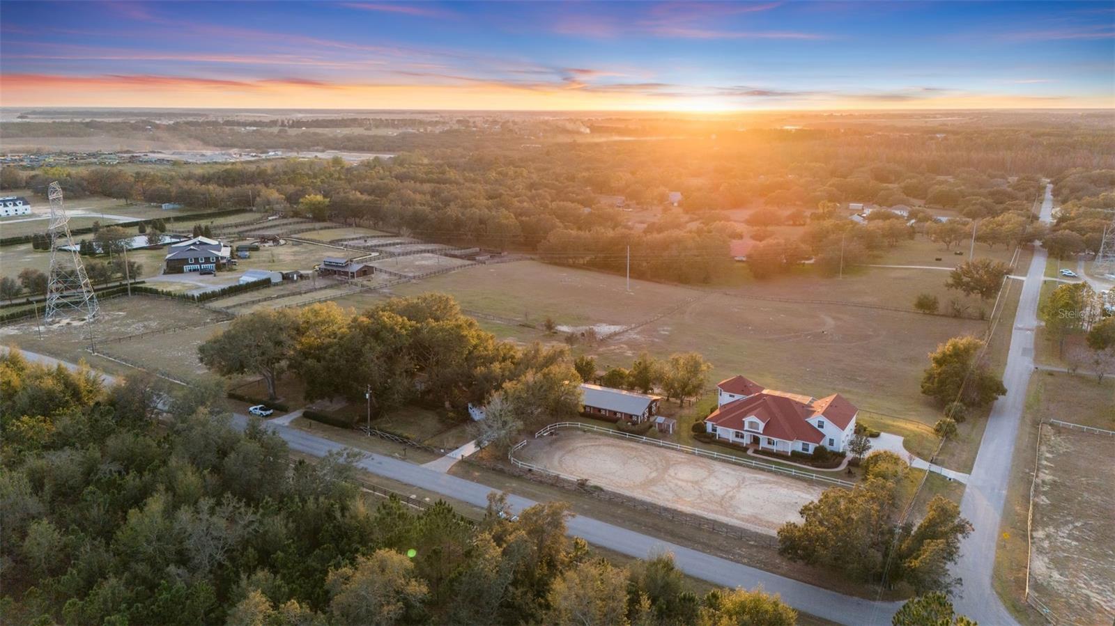 **A RARE OPPORTUNITY YOU WON’T WANT TO MISS!!** 9.75 PRIME ACRES IN THE HEART OF WINTER GARDEN ~ MAIN HOME CUSTOM BUILT BY HANNIGAN HOMES 5BD/4BA/3-CAR- 5,423 SQFT, INCLUDING AN ABOVE GARAGE APARTMENT WITH 1/BD/1/BA/+KITCHENETTE ~ SECOND HOME ON PROPERTY INCLUDES 4BD/2BA/2-CAR - 2,082SQFT ~ 10-STALL + TACKROOM HORSE BARN - 2,592 SQFT, 3 PASTURES ~ FENCED IN RIDING RING AND MUCH MORE! This countryside estate is an exclusive opportunity to own two homes, a horse barn, an adorable chicken coop, Koi pond, paver fire pit, built-in playground and so much more in the heart of the sought-after Winter Garden! Bring your horses and enjoy all that this massive CORNER LOT has to offer and being just minutes from the 429 gives you easy access to every convenience including neighboring HORIZON WEST and DISNEY THEME PARKS. Being sold all as one gives you endless opportunities in the ADDITIONAL SINGLE FAMILY HOME with the main home ready with charm for a family to make it their own. The long covered front porch welcomes you home and gives you front row seats to the riding ring. Built by Hannigan Homes, the main home was modeled after Disney’s Grand Floridian, and the thoughtful and unique features throughout are the perfect blend of comfort and quiet luxury. The roof was updated in 2019, the office space can serve as an additional bedroom, light and bright with views of the property, there is a movie/media room currently being used as an indoor trampoline park, WALK-IN WINE CELLAR for the adults, a fun HIDDEN WALK-IN PANTRY for ample kitchen storage and an energy saving SOLAR WATER HEATER. The new owner will absolutely fall in love with the PRIVATE PRIMARY SUITE that takes up the entirety of the second floor with sweeping views overlooking your estate, large WALK-IN CLOSET and well appointed ensuite bath. The additional bedrooms on the main floor give room to grow, and the additional home and garage apartment graciously allow for multi-general living. This gorgeous property is best experienced in person (stunning sunsets included!) so it can speak for itself - call today to schedule your private tour today!