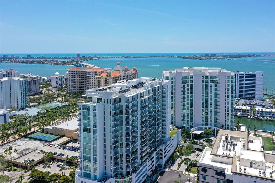 Prepare to be captivated by this absolutely stunning,12th-floor residence at Bayso, Sarasota’s most sought-after luxury tower at The Quay. With postcard worthy southern views of Sarasota Bay and the sparkling downtown skyline from every room, this extraordinary 2-bedroom plus den, 2.5-bath home offers nearly 1,600 square feet of refined sophistication and comfort. The moment you step inside, you’re greeted by a flood of natural light pouring through floor-to-ceiling glass, immediately drawing your eye to panoramic views that stretch endlessly across the bay and city. The elevated 20+ foot above sea level lobby sets the tone for the elegance that awaits above. Soaring 10-foot ceilings, porcelain tile flooring, and tastefully upgraded designer light fixtures throughout the home create a sleek and luxurious atmosphere. The spacious great room and dining area are the heart of the home; perfectly suited for entertaining, relaxing, or simply soaking in the view with your morning coffee or evening glass of wine. This is where everyday living transforms into something exceptional. Step outside to your oversized private terrace with glass railings and indulge in the beauty of Sarasota’s ever-changing skyline. The kitchen is a true showpiece, featuring European-inspired Italkraft cabinetry, glistening quartz countertops, a large center island with rollout drawers, premium Jenn-Air stainless steel appliances including an induction cooktop and double oven; making it ideal for both the everyday chef and the culinary enthusiast. The owner’s suite is a tranquil retreat, offering a spacious walk-in closet with custom built-ins and a spa-like bath complete with Grohe fixtures, double vanity with Robern recessed medicine cabinets, a separate water closet, and a glass-enclosed walk-in shower. The guest suite enjoys its own spectacular views, generous closet space, and a beautifully designed en-suite bath. A versatile den is outfitted with a custom wall unit with a queen-size Murphy bed, offering flexibility as a third bedroom, office, or private media space. A stylish powder room and an oversized utility room with full-size washer and dryer and abundant storage complete this perfectly designed residence. Bayso offers an unmatched array of resort-style amenities. Residents enjoy a 24/7 attended lobby, on-site management, and access-controlled security. The fifth floor is your personal oasis; featuring an elevated pool and spa deck over 60 feet above sea level, outdoor entertainment lounges, kitchen and grilling areas, the serene Splash Lounge, a state-of-the-art fitness center, movement studio, and a private dog park. There's even a formal club room with catering kitchen, co-working spaces, a boardroom for business meetings, secured Wi-Fi throughout all amenity spaces, and a mail room with package storage. The residence includes a premium assigned parking space in the private garage, climate-controlled storage, and there is also separate bicycle storage for the residents. All of this just steps from Sarasota’s thriving arts scene, award-winning dining, boutique shopping, and cultural venues; with the white sands of Lido Key, Longboat Key, and Siesta Key just minutes away. Whether you're seeking an elegant year-round home, a chic pied-à-terre, or a lock-and-leave retreat in one of Florida’s most desirable cities, this residence is your invitation to live the dream. Schedule your private tour today and experience the very best of luxury living at Bayso.