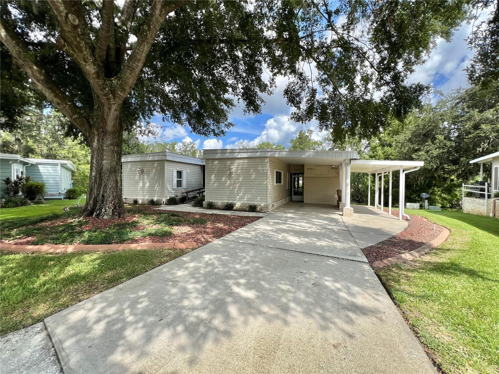 Discover this beautiful and unique home nestled at the end of a quiet cul-de-sac in the sought-after Hawthorne at Leesburg. Enjoy breathtaking 180-degree panoramic views of the river from the comfort of your spacious Florida Room, fully enclosed under heat and air for year-round enjoyment. This well-maintained home, ready for occupancy, features a long driveway with a dedicated golf cart pad and awning, offering plenty of parking and convenience. The upgraded vinyl siding adds to the home’s clean curb appeal, while the roof has been carefully maintained and the HVAC system was completely replaced in 2019 for peace of mind. Whether you’re relaxing in the expansive living space, taking in the river views, or enjoying the community’s amenities, this home offers comfort, space, and a truly special setting..........Hawthorne at Leesburg is an active, resident owned, 55+ cooperative, waterfront, gated community, with beautifully landscaped grounds, lakes with illuminated fountains and a relaxing and comfortable gazebo. The affordable monthly maintenance fee of $346 includes water, sewer, lawn mowing, private emergency services and storage space for recreational vehicles, boats, trailers and much more! The beautiful clubhouse is complete with a full-time program coordinator, more than 100 different activities and seating for 550. It has a hospitality lounge, card rooms, craft rooms, billiard room, fitness center, library, fine arts room and many more. There is excellent fishing, outdoor geo-thermally heated pool and two enclosed therapeutic pools. Hawthorne boasts a private marina monitored by an electronic security system with over 120 boat slips and access to the Harris Chain of Lakes and beyond.