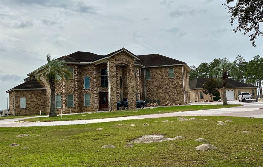 First time ever on the market....You could be living high on the hill with some of the most amazing views in Florida! This 8,700± sq ft executive pool home includes a 3,400± sq ft detached garage/workshop, dual master suites, 3 living rooms, fireplace, spacious kitchen, private den and a massive 2nd floor bonus room. Overall, the home has 4 bedrooms, 3 full baths, 2 half baths and an attached 3 car garage. This is no ordinary piece of land.....This is 156± acres with some of the highest (and possibly THE highest) elevations in Pasco County. Views are simply breathtaking and visibility is virtually unlimited. It's currently configured in 4 parcels ranging from 20± to 80± acres and could be ideal for future development or a family compound. Overall, the property has 3/4± mile of paved road frontage and 1/4± mile of grade road frontage. The home and property do need some work to look its best, but an opportunity like this is a rare, rare find.