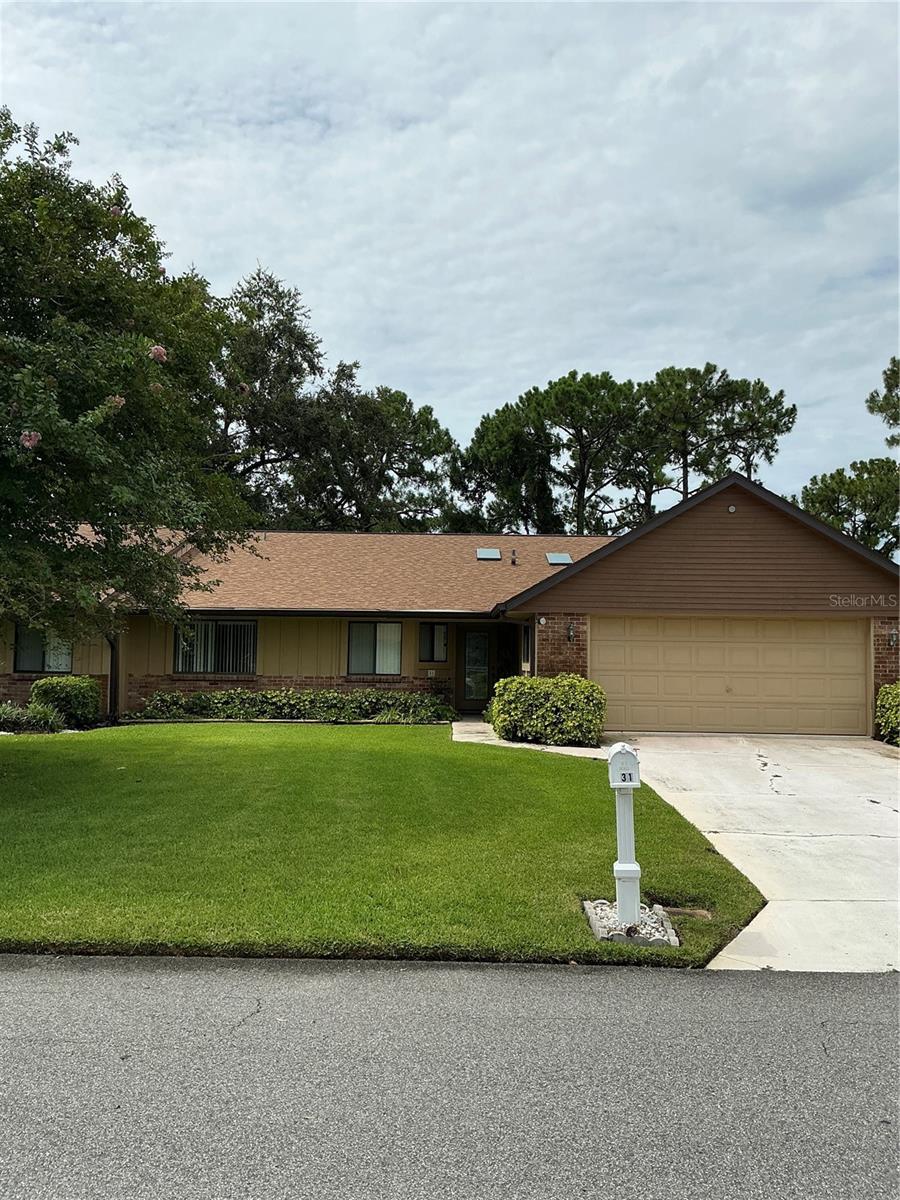 Nestled along the Third Fairway of Hidden Lakes Golf Course, one of the area’s most desirable golf course neighborhoods, this 3-bedroom, 2-bath home offers 2,000 square feet of comfortable living space. Enjoy golf course views from the spacious family room, living room and primary suite. Large windows throughout allow for natural light and tranquil views. The generous primary suite has an en-suite bath and two walk-in closets. The functional floor plan includes formal living and dining areas, a spacious family room, and a well-proportioned kitchen, all designed to accommodate both everyday living and entertaining. Generously sized bedrooms with ample closet storage, and an indoor laundry room off of the over sized two-car garage further enhance the home’s practical appeal. Built in 1986, this home has been well cared for by its original owners and provides a classic layout ready for your personal updates and renovations. Recent upgrades include a new roof in 2022, new HVAC and Electrical Panel in 2023, and a whole house Air Purifier in 2025. The kitchen also has newer microwave, dishwasher, faucet and garbage disposal. The clubhouse facilities and restaurants are easily accessible – only a golf cart ride away! The Homeowner’s Association provides lawn sprinklers and maintenance of common areas. This home is just 5 miles from the sandy shores of New Smyrna Beach, less than 20 miles from Daytona Beach & Daytona International Speedway and less than 50 miles from Kennedy Space Center.