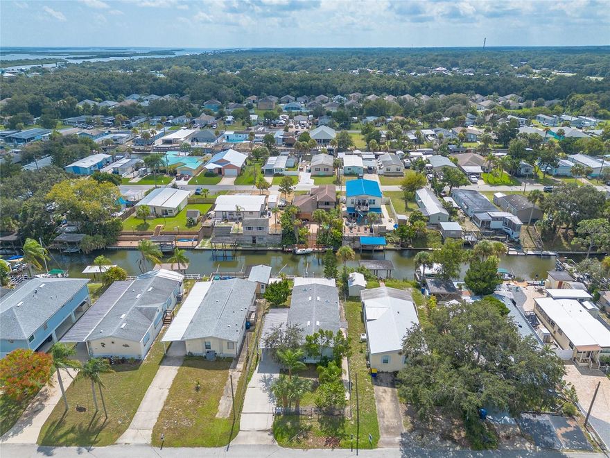 Welcome to 130 Charles Street in Edgewater, where coastal living meets everyday convenience with a fully fenced yard for privacy and security. This waterfront gem sits along a peaceful deep-water canal and features a seawall and davits to lift jet skis or kayaks with ease, granting direct access to the Intracoastal Waterway and beyond. The beautiful screened-in Florida Room overlooks the canal and seamlessly flows toward the Indian River, Mosquito Lagoon, and the Intracoastal, offering you exceptional views at every turn. The home was thoughtfully updated over the years: a new roof was installed in 2015, a hurricane carport was added in 2023, and the AC was replaced in October 2018. In 2022, new wiring was run to the seawall and boat davits. You’ll find approximately 50 feet of double-well concrete dock frontage, complete with 2 heavy-duty davits. The property even includes features from a previous accessibility remodel — the primary bath was designed for adaptable use, and the house had been adapted for wheelchair access. Nestled in the quiet, highly desirable South Waterfront Park neighborhood, this location is just moments from shopping, dining, and the sandy shores of New Smyrna Beach — all while preserving a serene waterfront retreat. Opportunities like this rarely come along: a uniquely equipped waterfront property with serious upgrades in one of Edgewater’s most coveted settings.