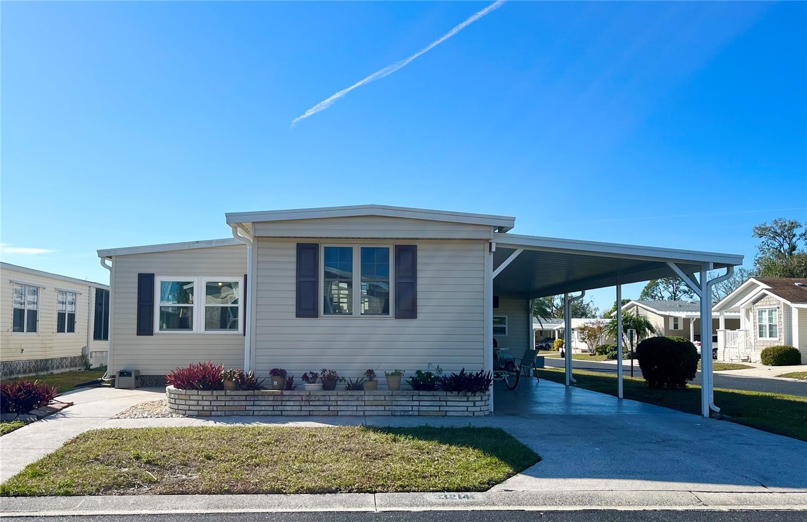 So many pluses to this home! Relax on the back DECK overlooking views of the CANAL and FOUNTAIN on this CORNER lot UPDATED open concept TURNKEY coastal beach style home. Whew that's a lot of pluses and more to add! Welcome your guest thru the epoxy front patio area or from the epoxy drive carport into a tranquil open concept with the spacious kitchen overlooking the living and dining room. The first thing that catches your eye in this remodeled kitchen is the extra large island and gorgeous iridescent glass backsplash. Extra island seating gives ample space for entertaining guest and tackling your favorite recipes. Final touches include the white shaker cabinets, a farm sink and stainless appliances. The living room has comfortable furnishings with 5 places to recline and a flat screen TV. The dining space is quaint and the farm style table is versatile allowing seating for 6 or drop a side and use it as a desk space or buffet serving table. The primary suite is so roomy that there is a king bed set and a cozy living space with love seat recliner and TV. Additionally there are 3 closets, access to the full bath and sliders to the private deck space. The main bathroom has been updated and the farm bench gives that homey touch. The guest bedroom has a queen bed and half bath. The washer and dryer, water heater and utility sink are housed in the 144sf shed that gives plenty
of room for additional storage space.
Updates include: Galv Metal Roof Over 2018, New carport 2018, Vinyl siding added 2018, Double pane windows approx 2021, HVAC 2011 with replaced blower motor, Vapor barrier was updated and 10 pillars. Kitchen opened to main living and remodeled 2018, Smart core engineered pro luxury vinyl flooring throughout main living-sleeping areas and 3/4" plywood subfloors 2018, Bathrooms have concrete vinyl flooring, Main bathroom remodeled 2018 with access to primary bedroom and main living area. Drywall in parts of living room/bathroom and guest bedroom. Water lines are copper with shutoffs, and the sewer line is original.
The gated 90 acre community boast a low maintenance fee with its vast amenities starting with the spacious Clubhouse outfitted with a full commercial cook kitchen, event stage, audio/visual, dance floor, state of the art fitness room, activities hall, library with books/movies/puzzles and a pool table. Outside recreation includes an extra large heated pool with a handicap ramp, a spacious kidney shaped hot tub, ample umbrella tables and lounge chairs and updated shower rooms. Oak trees shade the beautiful park area, picnic tables and a community grill. Additional amenities to enjoy are the community putt putt course, bocce ball, ping pong, horse shoes and corn hole. Oakwood Manor is a vibrant community with numerous social events and activities. Conveniently located adjacent to Legacy Trail and 12 newer pickle ball courts. Just a short drive to our crystal sand beaches, downtown area, the marina, fishing pier, local golf courses, shopping, variety of restaurants, the museum, SRQ airport, SMH and Doctors hospitals. Please note that Oakwood is a 55+, no pet, no motorcycle Park.