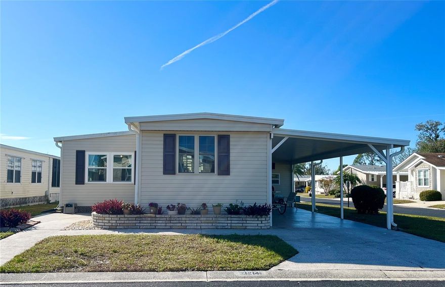 So many pluses to this home! Relax on the back DECK overlooking views of the CANAL and FOUNTAIN on this CORNER lot UPDATED open concept TURNKEY coastal beach style home. Whew that's a lot of pluses and more to add! Welcome your guest thru the epoxy front patio area or from the epoxy drive carport into a tranquil open concept with the spacious kitchen overlooking the living and dining room. The first thing that catches your eye in this remodeled kitchen is the extra large island and gorgeous iridescent glass backsplash. Extra island seating gives ample space for entertaining guest and tackling your favorite recipes. Final touches include the white shaker cabinets, a farm sink and stainless appliances.  The living room has comfortable furnishings with 5 places to recline and a flat screen TV. The dining space is quaint and the farm style table is versatile allowing seating for 6 or drop a side and use it as a desk space or buffet serving table. The primary suite is so roomy that there is a king bed set and a cozy living space with love seat recliner and TV. Additionally there are 3 closets, access to the full bath and sliders to the private deck space. The main bathroom has been updated and the farm bench gives that homey touch. The guest bedroom has a queen bed and half bath. The washer and dryer, water heater and utility sink are housed in the 144sf shed that gives plenty 
of room for additional storage space.
Updates include: Galv Metal Roof Over 2018, New carport 2018, Vinyl siding added 2018, Double pane windows approx 2021, HVAC 2011 with replaced blower motor, Vapor barrier was updated and 10 pillars. Kitchen opened to main living and remodeled 2018, Smart core engineered pro luxury vinyl flooring throughout main living-sleeping areas and 3/4" plywood subfloors 2018, Bathrooms have concrete vinyl flooring, Main bathroom remodeled 2018 with access to primary bedroom and main living area. Drywall in parts of living room/bathroom and guest bedroom. Water lines are copper with shutoffs, and the sewer line is original.
The gated 90 acre community boast a low maintenance fee with its vast amenities starting with the spacious Clubhouse outfitted with a full commercial cook kitchen, event stage, audio/visual, dance floor, state of the art fitness room, activities hall, library with books/movies/puzzles and a pool table. Outside recreation includes an extra large heated pool with a handicap ramp, a spacious kidney shaped hot tub, ample umbrella tables and lounge chairs and updated shower rooms. Oak trees shade the beautiful park area, picnic tables and a community grill. Additional amenities to enjoy are the community putt putt course, bocce ball, ping pong, horse shoes and corn hole. Oakwood Manor is a vibrant community with numerous social events and activities. Conveniently located adjacent to Legacy Trail and 12 newer pickle ball courts. Just a short drive to our crystal sand beaches, downtown area, the marina, fishing pier, local golf courses, shopping, variety of restaurants, the museum, SRQ airport, SMH and Doctors hospitals. Please note that Oakwood is a 55+, no pet, no motorcycle Park.