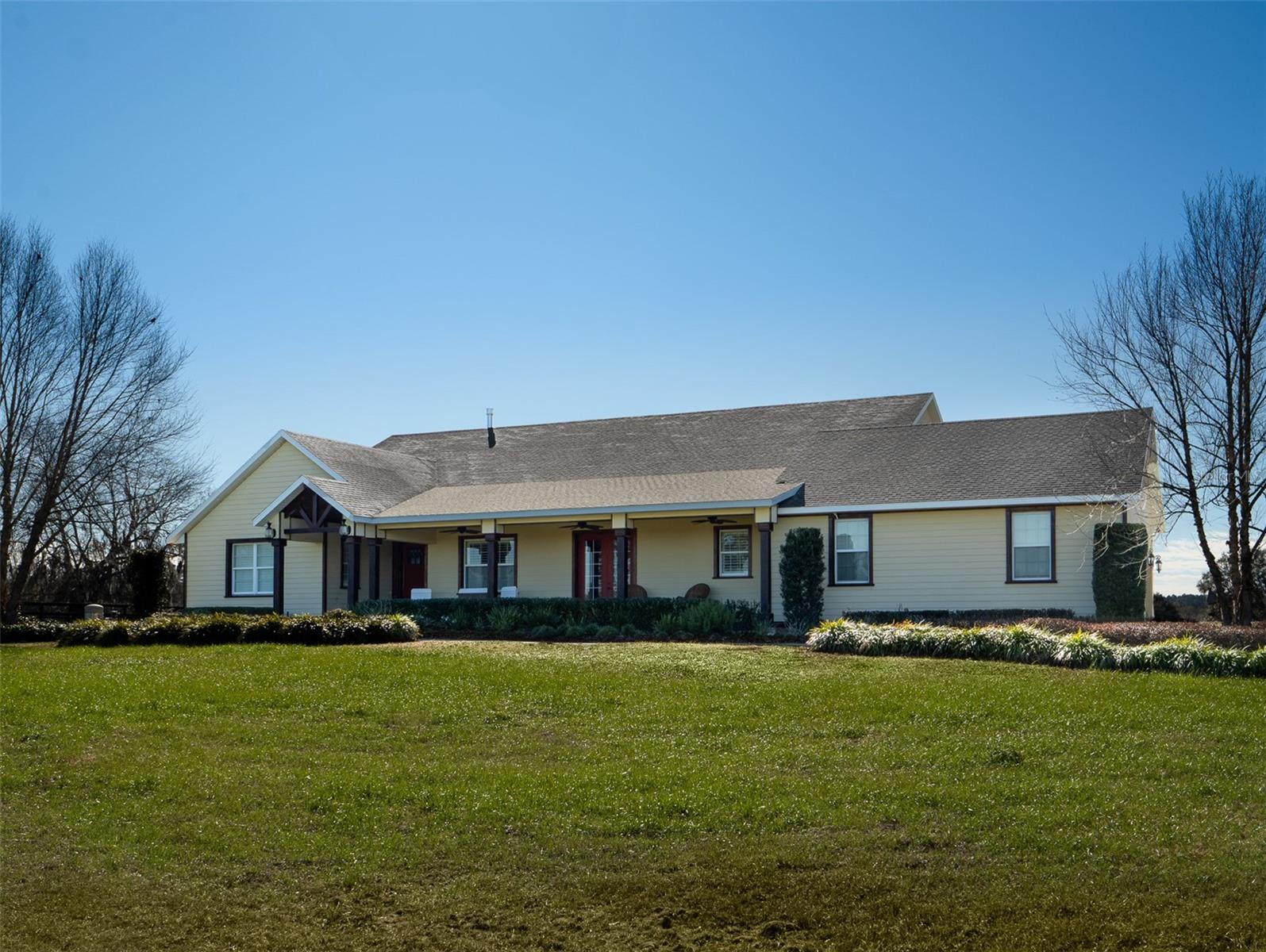 This beautiful property is perfectly located just 10 minutes from the World Equestrian Center and 5 minutes from HITS, making it an ideal spot for equestrian enthusiasts! Fully fenced and featuring 9 paddocks, the property provides ample space for your horses or a variety of other uses. The home offers 4 bedrooms and 4 full bathrooms, with an open floor plan that provides a spacious, inviting atmosphere. High ceilings and an abundance of windows to let in natural light, while the breakfast nook and separate formal dining area offer flexibility for both casual and formal meals. French doors lead out to a spacious screened-in back patio with a heated pool and spa, perfect for relaxing or entertaining. This property combines the tranquility of country living with proximity to top equestrian venues, making it a fantastic place to call home!