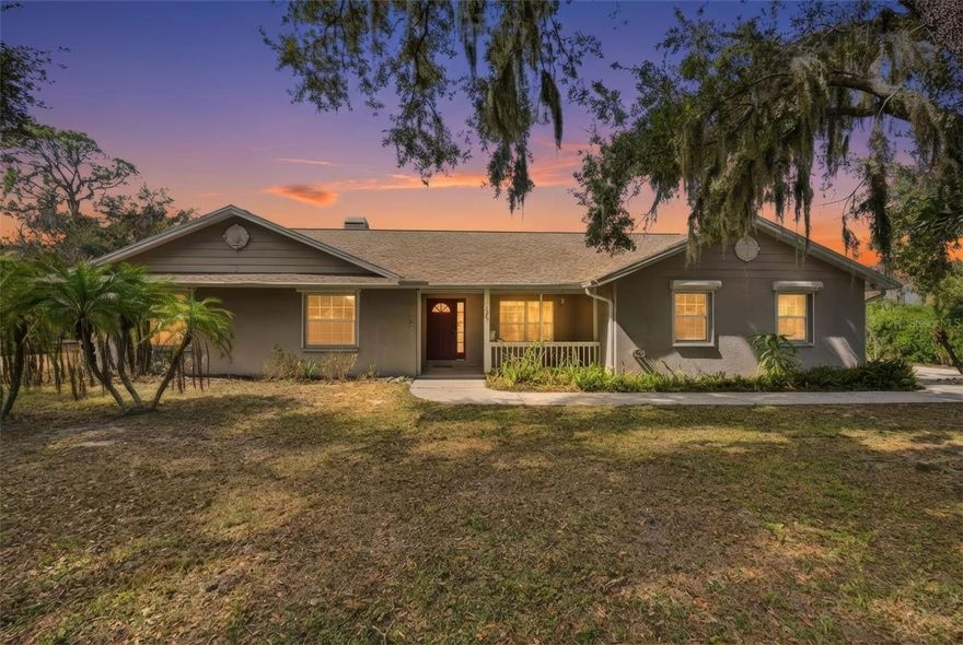 Tucked away on two private acres in Palmetto, yet just minutes from the exciting new shopping and dining in Parrish, this rare property offers the best of both worlds—peaceful Old Florida charm with unbeatable convenience and no HOA restrictions. Bring your boats, RVs, trailers, commercial vehicles, and all your toys while still enjoying privacy and space. The free Bishop Harbor boat and kayak launch is less than a mile down the road, offering easy access to Tampa Bay for a day of boating, fishing, or sunset cruising. With convenient access to Tampa, St. Petersburg, Sarasota, and the area’s beautiful Gulf beaches, you’re perfectly positioned while still feeling a world away.

This 4-bedroom, 2-bath home with a dedicated den and oversized 2-car garage offers solid block construction, generously sized bedrooms, and endless potential to make it your own. Inside, you’ll find beautiful real wood floors and a cozy wood-burning fireplace that adds warmth and character throughout the home. The big-ticket items have already been taken care of, including a new roof in 2021, a new A/C in 2023, new water heater and whole-house repipe in 2025, and motorized hurricane shutters for added protection and peace of mind.

Step outside to your peaceful acreage, where majestic mature oaks draped in Spanish moss create a picture-perfect backdrop. Relax on the spacious rear screened lanai—ideal for savoring morning coffee or unwinding with breathtaking sunset views. In front, a charming porch with a welcoming swing sets the tone, capturing the timeless charm of classic Florida living.

Private acreage, major system updates already completed, boat access just down the road, and close proximity to everything the Gulf Coast has to offer—opportunities like this are increasingly rare. You won’t believe this still exists. Don’t wait—schedule your showing today!