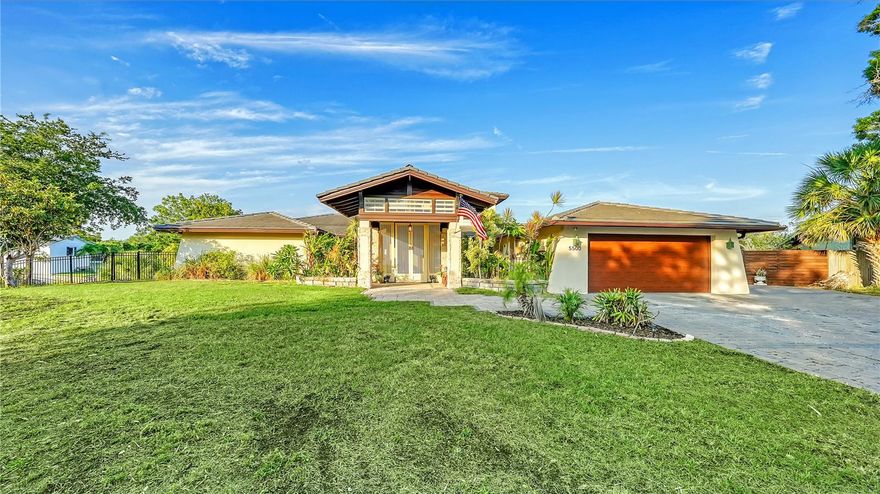 One or more photo(s) has been virtually staged. Live the Ultimate Florida Lifestyle in This Waterfront Paradise! Nestled in the heart of Phillippi Gardens, this extraordinary property offers the perfect blend of tranquility, luxury, and convenience. Set on an OVERSIZED .61-ACRE LOT WITH OVER 400 FEET OF PRIVATE WATER FRONTAGE. Along two serene waterways just off Phillippi Creek, this home is a true tropical oasis—peaceful and secluded, yet minutes from everything Sarasota has to offer. Inside, the residence showcases a flexible layout with FOUR SPACIOUS BEDROOMS, some easily adaptable for office, studio, or guest use, and FOUR FULL BATHROOMS making it ideal for hosting loved ones and guests. The interior has been thoughtfully updated from 2017 through 2024 blending modern comfort with timeless charm. Interior Highlights Include: An expansive great room with a DUAL-SIDED WOOD-BURNING FIREPLACE, a gourmet kitchen featuring stainless steel appliances, farmhouse sink and pot filler. Three bedrooms on the main level, including one en-suite, and a second-floor master suite with a PRIVATE BALCONY OFFERING BREATHTAKING SUNRISE AND SUNSET VIEWS. Step outside and feel like you're on vacation every day. The lush, tropical grounds are packed with resort-style amenities: Tiki hut with a full bar and grill, two fire pits, five-zone low-voltage night lighting creating a magical evening ambiance, heated pool and spa, boat lift, a new boathouse (2019) and new seawall (2023/2024). Additional Upgrades: Two new A/C units (2019), septic-to-sewer conversion (2018). Tucked away at the end of a quiet cul-de-sac, this home offers privacy without sacrificing accessibility. You're just a short bike ride to the Gulf beaches, near The Landings for shopping and dining, and minutes from downtown Sarasota’s vibrant arts and culture scene.