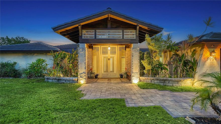 Live the Ultimate Florida Lifestyle in This Waterfront Paradise! Nestled in the heart of Phillippi Gardens, this extraordinary property offers the perfect blend of tranquility, luxury, and convenience. Set on an OVERSIZED .61-ACRE LOT WITH OVER 400 FEET OF PRIVATE WATER FRONTAGE. Along two serene waterways just off Phillippi Creek, this home is a true tropical oasis—peaceful and secluded, yet minutes from everything Sarasota has to offer. Inside, the residence showcases a flexible layout with FOUR SPACIOUS BEDROOMS, some easily adaptable for office, studio, or guest use, and FOUR FULL BATHROOMS making it ideal for hosting loved ones and guests. The interior has been thoughtfully updated from 2017 through 2024 blending modern comfort with timeless charm. Interior Highlights Include: An expansive great room with a DUAL-SIDED WOOD-BURNING FIREPLACE, a gourmet kitchen featuring stainless steel appliances, farmhouse sink and pot filler. Three bedrooms on the main level, including one en-suite, and a second-floor master suite with a PRIVATE BALCONY OFFERING BREATHTAKING SUNRISE AND SUNSET VIEWS. Step outside and feel like you're on vacation every day. The lush, tropical grounds are packed with resort-style amenities: Tiki hut with a full bar and grill, two fire pits, five-zone low-voltage night lighting creating a magical evening ambiance, heated pool and spa, boat lift, a new boathouse (2019) and new seawall (2023/2024). Additional Upgrades: Two new A/C units (2019), septic-to-sewer conversion (2018). Tucked away at the end of a quiet cul-de-sac, this home offers privacy without sacrificing accessibility. You're just a short bike ride to the Gulf beaches, near The Landings for shopping and dining, and minutes from downtown Sarasota’s vibrant arts and culture scene.