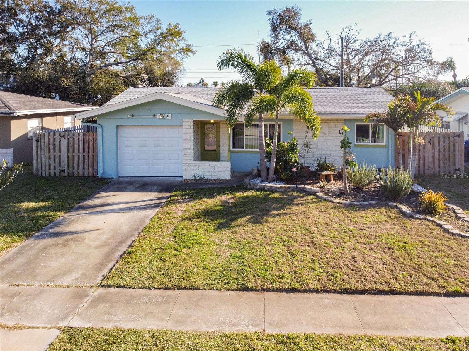 HARDWOOD FLOORS | UPDATED ROOF | UPDATED WINDOWS & DOORS | 140 Square Foot BONUS ROOM | NEW TOOL SHED | 1 CAR GARAGE WITH AUTOMATIC DOOR |
Welcome to 2718 Keene Park Drive – Your Ideal Coastal Retreat in the Heart of Largo!
Looking for the perfect Florida home near the coast? This midcentury gem offers easy access to Tampa and St Pete – Clearwater International Airports, while also being just a short drive from shopping and recreational activities. With features like gleaming HARDWOOD FLOORS, modern STAINLESS STEEL APPLIANCES, and a FENCED BACKYARD, this two-bedroom, nearly two-bathroom home boasts his and hers closets in
the primary bedroom, a one-car garage, and ample storage space.
Prime location near the Pinellas Trail, Allen’s Creek, and Eagle Lake Park!
The updated landscaping features vibrant palms and lush fruit trees—mango, banana, key lime, loquat, and bitter orange—adding natural beauty and charm. The yard is easily maintained with reclaimed water irrigation, a new solar-powered shed, and a lit gazebo with a vented top, perfect for relaxing or entertaining outdoors.
Call today and set up your private showing!
