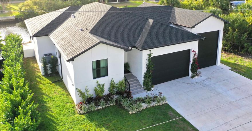 Discover this new, custom-built 2024/2025 waterfront home! Featuring 3 bedrooms, an office, 2.5 baths, and a rare attached RV shop alongside a 2-car garage, this property is located in a peaceful, no-HOA neighborhood. Enjoy City Water and Septic, with canal access just minutes from open water—perfect for boating enthusiasts.

This home offers 1,950 sq. ft. under air and 3,254 total sq. ft. under roof. The 40-foot, drive-through RV shop is cooled by a 24k BTU mini-split A/C and features epoxy flooring, 14-foot hurricane-impact-rated insulated garage doors, and ample storage for vehicles, RVs, and marine gear.

Built for durability and comfort, the home includes hurricane-impact windows and doors and spray foam insulation throughout the roof. Inside, you’ll find refined finishes, solid-core 8’ doors, 10’ ceilings, and custom-built closets with shelving. The primary suite is a private sanctuary with a large walk-in closet and a luxurious bath featuring a floor-to-ceiling tiled shower.

The chef’s kitchen offers white shaker cabinetry, quartz countertops with waterfall edges, a walk-in pantry, and an open dining area ideal for entertaining. Additional features include a separate utility room with sink and cabinetry.

Homes like this are rarely available—schedule your private showing today!