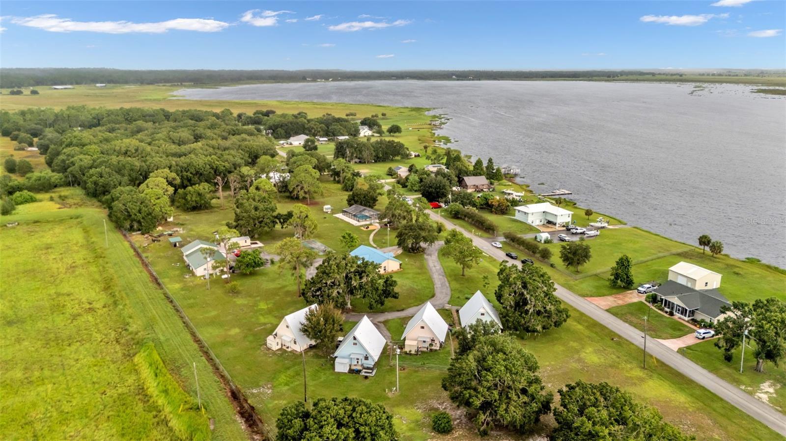 Here’s the opportunity you’ve been waiting for, a rare multi-unit income producing property! There are 8 units total, currently being rented out on a month-to-month basis. The property is nestled on nearly 4 acres under a canopy of old Florida charm, this one-of-a-kind property features a 3bd/2ba main residence, 4 architecturally charming A-frame 2bd/2ba cottages, and a multi unit apartment building with two units that are 1bd/1ba and one unit that’s a 2bd/1ba. All grandfathered under ARR zoning. The grounds are thoughtfully designed to offer both privacy and community, including a screened–in saltwater pool (new pump and recently resurfaced), garden pathways, shaded gathering areas, and plenty of parking. Just a stones throw away from the public boat ramp to crooked lake, where your guests or tenants can enjoy year round, boating, kayaking, and world class fishing. There’s also an Internet tower for fast Internet, property wide water softener system, a Generac generator for the apartment building, two large sheds, 6 smaller storage sheds, large chicken coop with run, fruit trees including mango, starfruit, cherry, lemon, lychee, pomegranate, banana, and numerous other young fruit trees. The main home was built in 2015 has a metal roof, carport, two open porches, and comes furnished including washer and dryer. All 4 A-frame cottages have new metal roofs as of April 2025 and all new HVAC systems. The 2/1 apartment also has a huge bonus room with a loft and a private laundry room (which could be turned into a 4th unit). But that’s not all there’s also a RV 30 amp hook up (with ample space for up to 9+ more) envisioning the potential for 10+ oversized RV pads, this property combines existing cash flow with development upside potential. This property is not just a residence or average income producer – it’s a flexible income–generating resort with limitless potential:think short-term vacation rentals, wellness retreats, church camps, rehabilitation centers, RV expansion, corporate rentals, live + earn model, or multigenerational living.