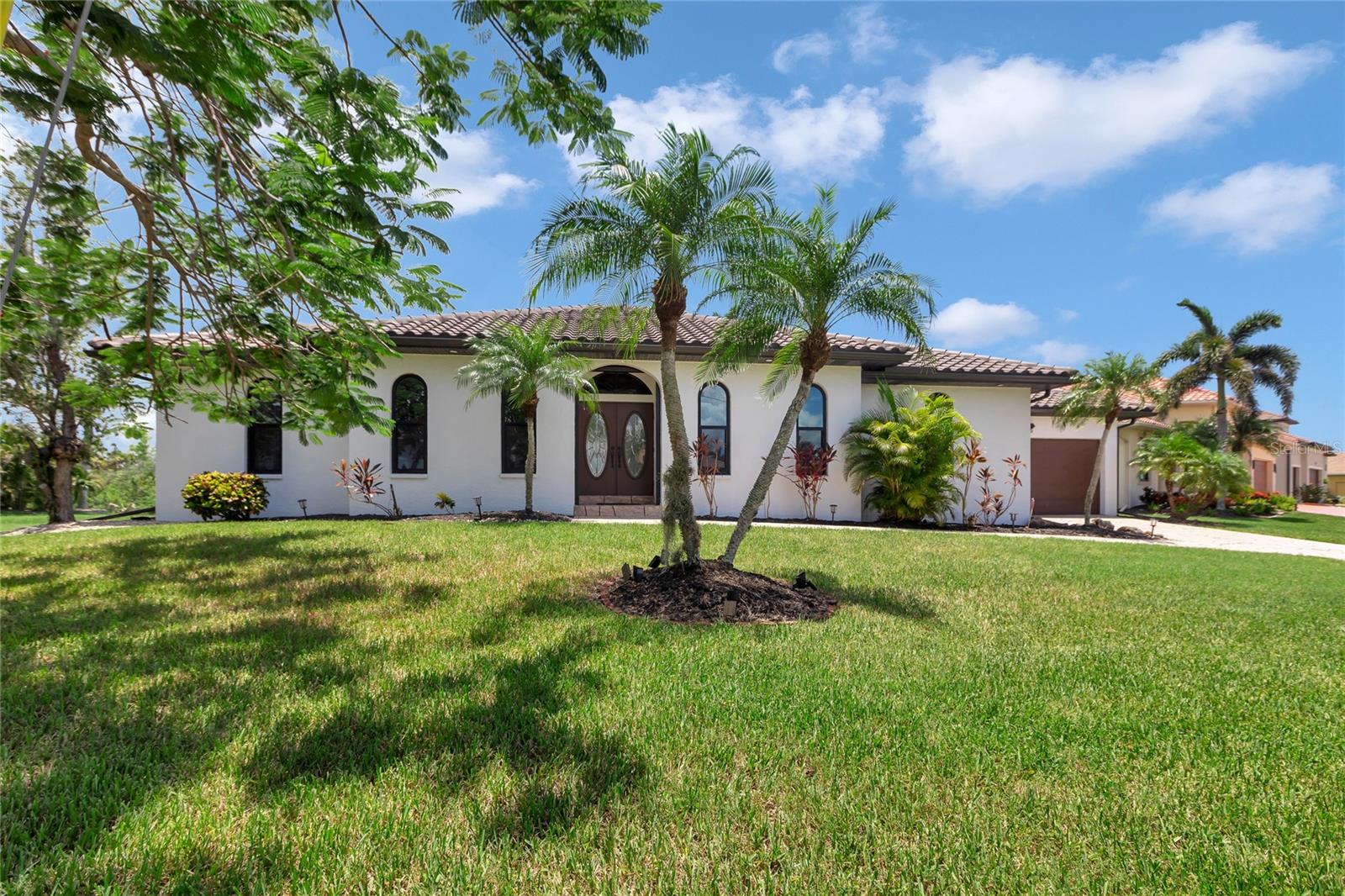Prepare to be captivated by this extraordinary Gulf Access waterfront estate, masterfully designed to deliver an unparalleled blend of elegance, comfort, and the ultimate Florida lifestyle in the prestigious Burnt Store Isles community.
From the moment you arrive, you’ll be swept away by the impeccable curb appeal, lush tropical landscaping, & the stunning Royal Poinciana tree gracing the front yard. This remarkable 3,400 sq ft residence has been meticulously maintained & thoughtfully updated with a new tile roof, soffits, gutters, LED lighting, impact windows, and fresh exterior paint, offering true peace of mind for years to come.
Property is high, dry, & had no flooding from storms.
Inside, you’ll discover a beautifully appointed Great Room floor plan that welcomes you with a grand corridor foyer, flanked by a formal dining room & an elegant home office—perfect for today’s work-from-home lifestyle. The formal living area flows effortlessly into a breathtaking gourmet kitchen, inviting breakfast nook, & a spacious family room adorned with rich wainscoting, recessed lighting, & a picture window that fills the space with natural light.
This residence is offered fully furnished, inviting you to embrace a world of refined coastal luxury from day one. Each living space is tastefully appointed with high-end pieces that perfectly complement the home’s open, airy layout & serene waterfront setting.
The chef’s kitchen is sure to impress featuring luxurious Quartz countertops, a designer tile backsplash, top-of-the-line stainless steel appliances, a wine cooler, an oversized island, & a convenient breakfast bar beneath a dramatic skylight.
This exceptional home offers four spacious ensuite bedrooms designed for privacy, relaxation, & the ultimate in comfort. Each boasting large windows, generous closet space, & private bathrooms, providing the perfect retreat for family & guests alike.
Step through elegant French doors into the luxurious owner’s suite, where you’ll wake each day to tranquil waterfront views of the saltwater canal, pool, & spa. The owner’s ensuite bath is a spa-like sanctuary, complete with an impressive 11’ x 6’ cedar walk-in closet with custom organizers, an expansive marble double vanity, abundant cabinetry, & a grand Roman shower.
Step outside and indulge in your private backyard oasis, where a sparkling heated pool & spa await, with updated Pentair wireless controls, heaters, & lighting for effortless enjoyment. Boating enthusiasts will delight in the Golden 10,000 lb. boat lift (2022) & new concrete dock, providing instant access to sailboat water with no bridges between you & the pristine waters of Charlotte Harbor & the Gulf of Mexico.
This move-in ready home is equipped with impact windows (2022), accordion shutters, & an electric impact rolldown screen (2022) for added security and storm protection. A comprehensive Xfinity Alarm System & three Ring doorbell locations provide additional peace of mind.
Located in the highly desirable Burnt Store Isles—an exclusive Gulf Access waterfront community with a public golf course, friendly deed restrictions, a low voluntary HOA fee, & direct access to endless boating and fishing adventures—this is truly the Florida lifestyle you’ve been dreaming of.
Schedule your private showing today and experience firsthand the unmatched luxury, thoughtful updates, & serene beauty of this spectacular waterfront haven. This is more than a home—it’s a lifestyle.