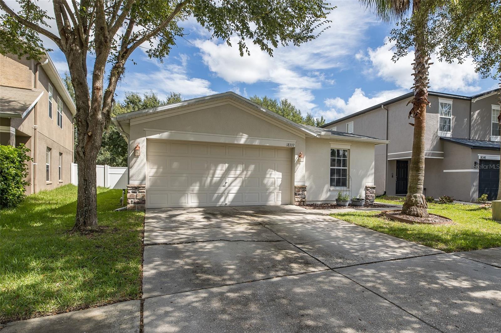 This 3/2/2 awaits your arrival. WELCOME HOME TO CONCORD STATION. This charming home flows beautifully and has exceptional functionality with a big vinyl fenced in backyard. Newer quality washer and dryer. Located in the premier growing area of Land O Lakes. A rated schools. Within minutes of Suncoast Pkwy. NEW ROOF, 2021 AC, NEW CARPET. This adorable home is priced for affordability to many. VINYL FENCING. The neighborhood is exceptionally quaint. Community includes LOW HOA, clubhouse, pool, pickleball/tennis, fitness center, playgrounds and much more! Miles of running and biking paths and near many hospitals, shopping and dining. Seller is offering a nice incentive for paint and flooring.
