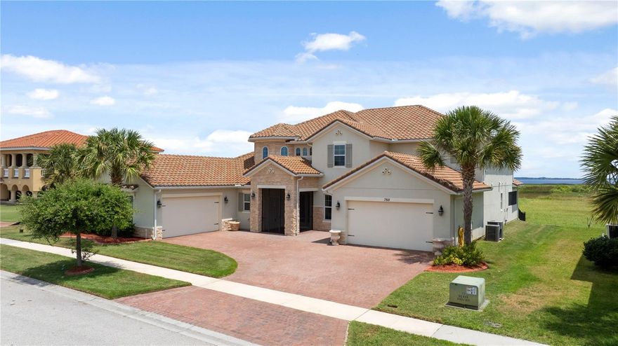 Welcome to refined lakefront living in the exclusive gated community of Bellalago, where privacy, scale and lifestyle converge seamlessly. This exceptional Spanish Mediterranean estate offers over 5,400 square feet of thoughtfully curated living space, featuring five bedrooms, 5.5 baths, soaring 20-foot entrance ceilings, 8-foot doors and breathtaking private views of Lake Toho. Designed for discerning buyers seeking sophistication and functionality, the residence showcases dual primary suites on both levels, two laundry rooms, an expansive upstairs loft and a private balcony overlooking the water, ideal for multi-generational living, executive entertaining or a luxurious second-home retreat. At the center of the home, the gourmet kitchen blends elegance and practicality with granite countertops, 42-inch cabinetry, a walk-in pantry, a butler's pantry and a dedicated drop zone area, all flowing effortlessly into the home’s grand living spaces. Expansive glass and natural light frame the home’s serene waterfront setting, while the oversized screened lanai creates a resort-inspired outdoor experience designed for peaceful mornings, sunset evenings and elevated entertaining in complete privacy. Located less than 30 minutes from Walt Disney World Resort and moments from premier shopping and dining, Bellalago is known for its tranquil atmosphere, boating lifestyle and resort-caliber amenities, including a clubhouse, fitness center, restaurant, multiple pools, tennis and basketball courts, volleyball courts, playgrounds, a dog park, private lake access and 24-hour guarded security. A rare opportunity to own a private waterfront residence in one of Central Florida’s sought-after luxury lake communities.