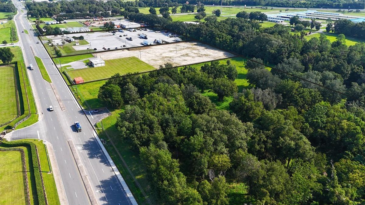 Prime Commercial Land for Sale!
This excellent property boasts a prime location with convenient access from both the North and South via NW 44th Avenue. B-5 Zoning allows for a variety of business types from retail, wholesale, repair, and service. Situated just North of US HWY 27 & I-75 interchange, this land offers easy access to I-75.
Buyers have the option to purchase 1, 2, or all 3 parcels zoned B-5 with land use of Specialized Commerce District. The combined parcels total 21.07+/- acres, comprising a 9.04+/- parcel, a 4.96+/- parcel, and a 7.07+/- parcel. There are currently 120 parking spaces which are fenced and lighted. There is also an office on one of the parcels
Located in the NW, Ocala’s most sought-after demographic areas, this development is perfect for businesses looking for prominence and accessibility. Prospective buyers can design their workspace from the ground up, selecting their preferred layout and interior finishes to create an environment that perfectly reflects their brand and meets their operational needs. Don’t miss out on this exceptional chance to establish your business in this thriving location.