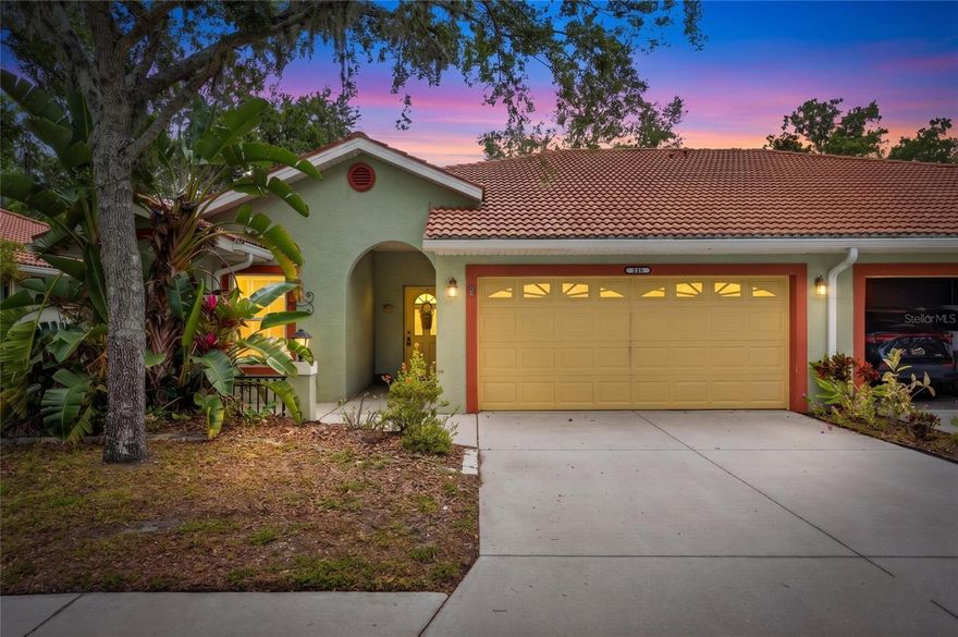 Tucked within a welcoming 55+ community, this beautifully maintained two-bedroom, two-bath villa with a two-car garage offers the ease of low-maintenance living without sacrificing comfort or charm. Soaring vaulted ceilings and warm floors set the tone the moment you walk in. An open, airy living space that feels both spacious and inviting. The seamless flow from living room to dining area to kitchen makes entertaining effortless, while sliding glass doors draw your eye straight through to the screened lanai and the tranquil pond beyond. The primary suite is a true retreat; generous in size, bathed in soft natural light through plantation shutters.  A private slider opens directly to the lanai, making morning coffee in the fresh air a daily luxury, with an ensuite bath just steps away.  The dedicated office/den is equally impressive.  Outfitted with custom built-in cabinetry, glass-front uppers, a wraparound desk, and generous storage from floor to ceiling. Whether you're working from home or simply need a beautiful space to organize your life, this room delivers. And finally, there's the view! Moss-draped live oaks framing a serene pond, reflected sky, and the quiet rhythm of Old Florida at its finest.