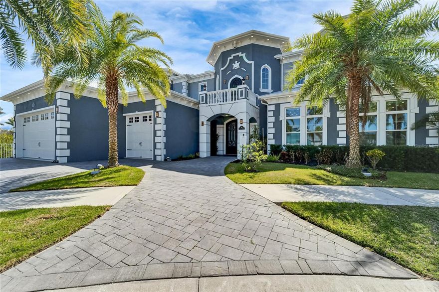 This extraordinary waterfront estate at 401 Bahama Grande Blvd in Apollo Beach is a one-of-a-kind masterpiece offering over 8000 sqft of meticulously designed living space. Located in a gated community on a quiet cul-de-sac, this home offers 270-degree water views and over 147 feet of waterfront frontage with direct access to Tampa Bay. Adjacent lot can be purchased separately.

Builders own personal home has been Built with solid block construction on all floors and cement flooring on each level, this estate is engineered for strength and peace of mind. Hurricane-impact-rated windows and doors, a seamless metal roof, and a cement perimeter provide exceptional storm protection. The expansive dock features WiFi, security cameras, an outdoor shower, and three covered boat lifts (14k lb, 10k lb, and 10k lb). Ownership extends far into the canal, further enhancing this property’s value.

Step inside through grand double doors to a stunning entryway with a custom airbrushed 30-foot ceiling, an elevator for seamless access to all levels, and a curved marble staircase adorned with chandeliers. The three-story great room showcases a dramatic fireplace and a glass wall overlooking the infinity-edge pool with a knife-edge design, slide, diving board, and hot tub. The expansive outdoor living space offers an 18x18 outdoor kitchen with a grill, smoker, pizza oven, sink, ice machine, and refrigerator—perfect for waterfront entertaining. The adjoining lot is available for purchase with a landscaped yard which includes a sports court, playground area, inground trampoline, and cozy firepit.

The gourmet kitchen is equipped with custom quiet-closure cabinetry, high-end Dacor appliances, a built-in Miele espresso machine, a gas cooktop, and a full butler's prep kitchen with a separate refrigerator and coffee bar. A custom glass-enclosed wine cellar with room for 100 bottles serves as a striking showpiece. 

The first-floor primary suite is a private retreat with breathtaking water views, a spa-inspired bath with illuminated custom mirrors, automatic heated toilets with bidets, dual showerheads, an oversized jetted tub, and an expansive custom-built dressing room with an island featuring custom storage solutions. Two additional guest bedrooms have private full baths, including jetted tubs. A third and 4th guest bedroom features a fully tiled bath and custom closets. The media room offers a world-class cinematic experience with a Sony 4K projector, a 120-inch screen, 11.1 surround sound, reclining massage chairs, and a dazzling starlight ceiling. Adjacent to the theater room, a full bar with walk-out balcony access creates a perfect entertainment space.

The third floor boasts yet another private suite with a spacious balcony.

This smart home features automation with Amazon Alexa and iPad control for security, lighting, sound, pool settings, video/TV, front door access, and irrigation. The custom lighting control system extends to both the home’s interior and exterior. Full landscape lighting with an outdoor sound system enhances the ambiance. Sixteen audio zones with over 32 speakers allow customized sound throughout. The home is partially powered by an owned solar system  with an automatic 48k LP generator for added efficiency and safety. Additional highlights include a six-space indoor garage with audio, security, and an EV charger, plus a spacious 40ft x 40ft drive.
