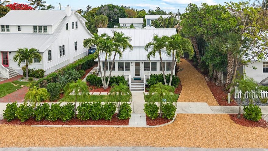 Nestled in the heart of Boca Grande’s coveted “Historic District”, this enchanting two-bedroom, two-bathroom, plus bunkroom Palm Cottage built in 1906 has been thoughtfully reimagined with refined designer finishes and modern conveniences throughout. As you walk up to the property you are greeted by lush tropical landscaping, offering both privacy and vivacious natural beauty. Inside, the front sitting room and dining area is bathed in natural light, creating an inviting space equally suited for tranquil mornings or intimate gatherings with family and friends. At the center of the home, the living room and kitchen blend effortless comfort with understated sophistication. An open-concept design is enhanced by custom built-ins, a charming reading nook, and a generous central cooking island – ideal for entertaining. Overhead, a beautifully crafted tongue-and-groove stained wood ceiling adds warmth and architectural character. The primary suite serves as a serene retreat, complete with a spacious walk-in closet and a spa-inspired en-suite bath featuring a beautifully appointed shower. French doors open directly to the rear porch, inviting seamless indoor-outdoor living. The backyard presents a rare opportunity to curate your own private oasis, with ample space to envision a pool, pavilion, or thoughtfully designed entertaining terrace. This exceptional cottage captures the essence of Boca Grande living – timeless, relaxed, and effortlessly elegant. Both an addition and pool/spa have been professionally designed for the Property. The Cottage is Rental Ready and has excellent rental history! Schedule your private showing today and experience this Cozy Cottage firsthand.